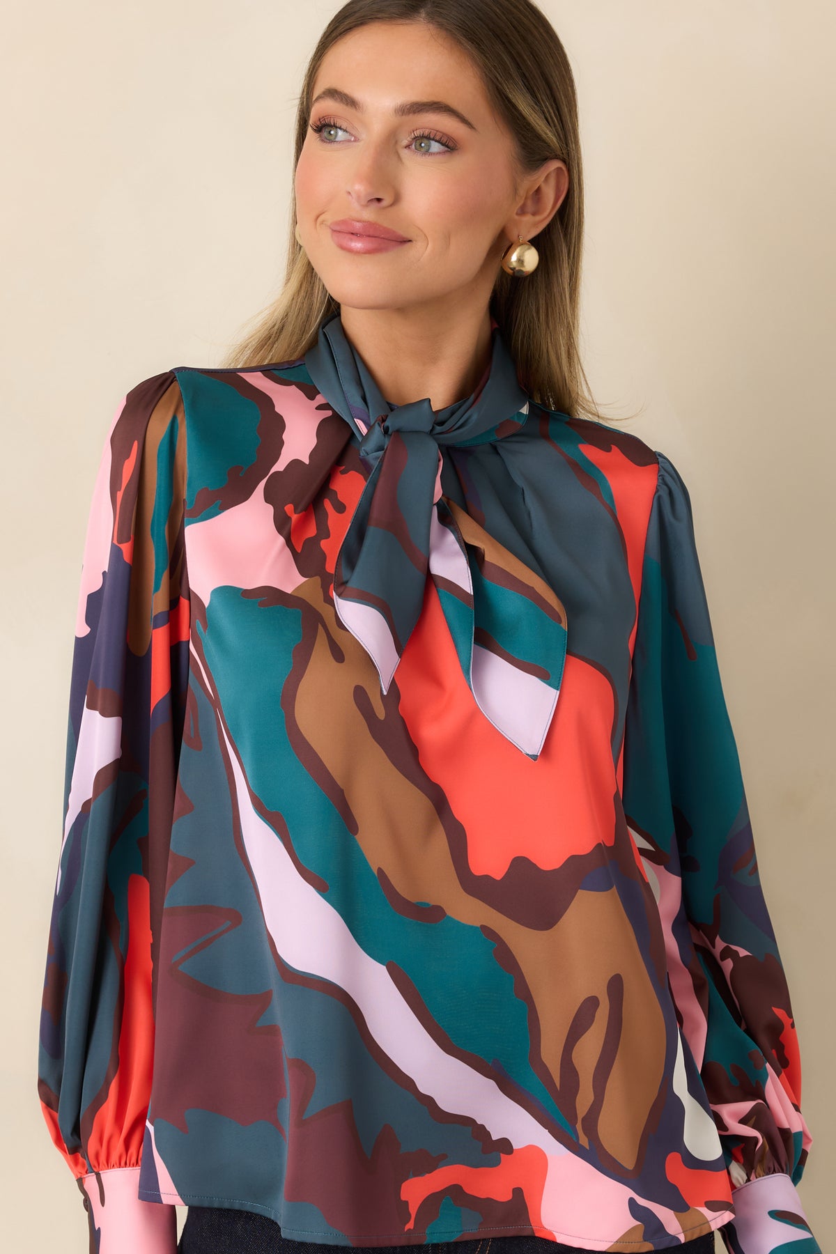Removable neck tie arranged at the round neckline of the colorful study print top.