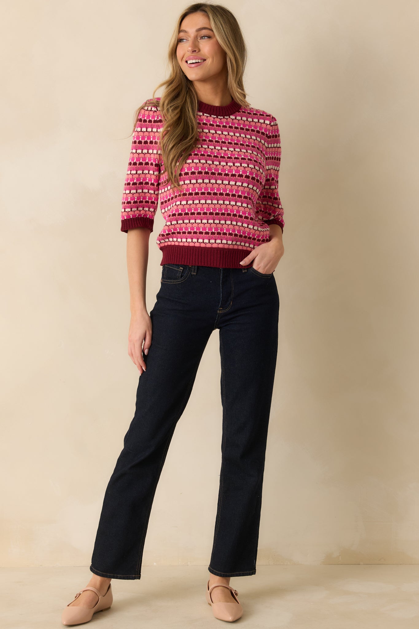 The sweater shows the colorful striped pattern across the body and sleeves for a polished, casual fit.