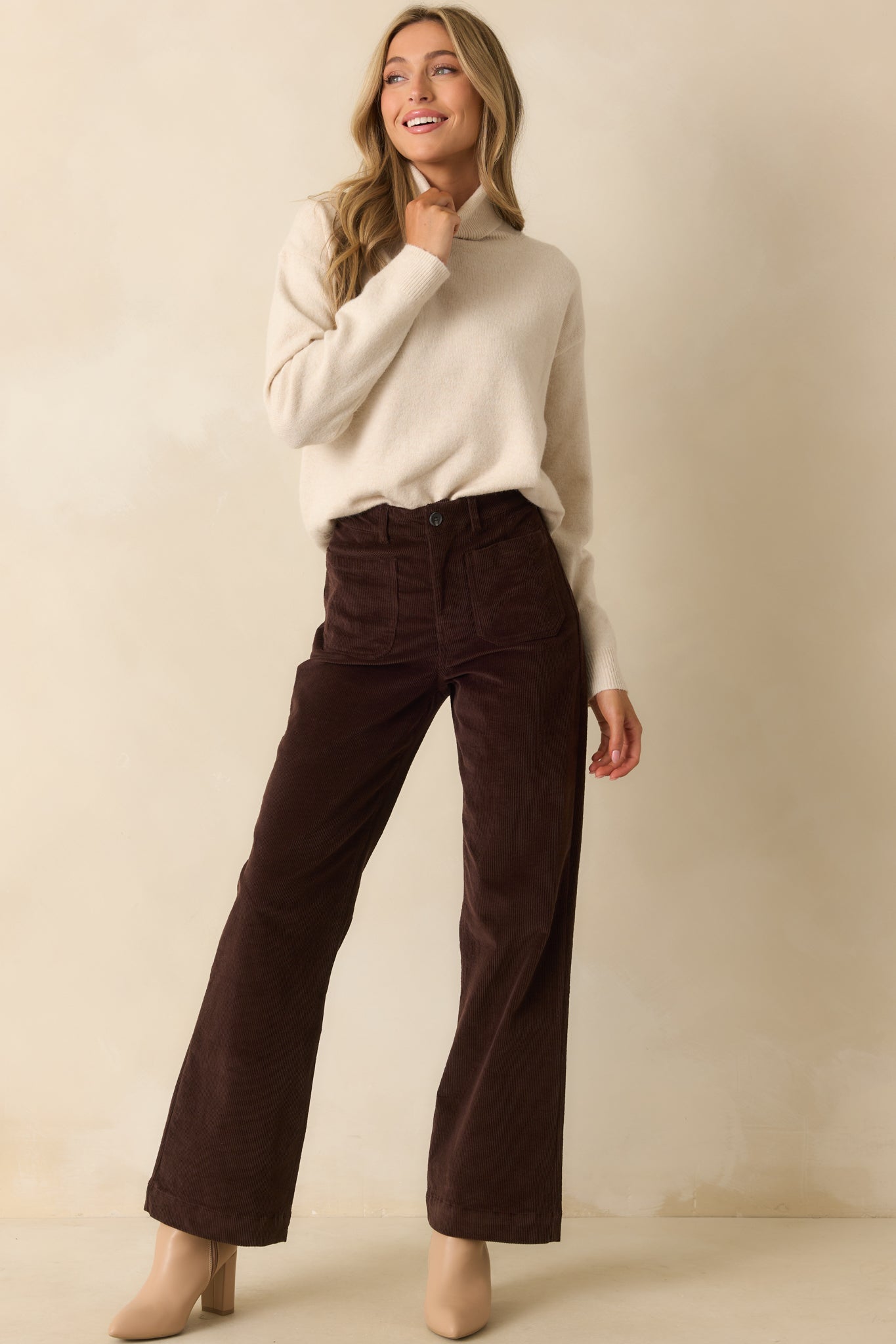 Full-length front view of sweater emphasizing turtleneck collar and relaxed, straight silhouette.