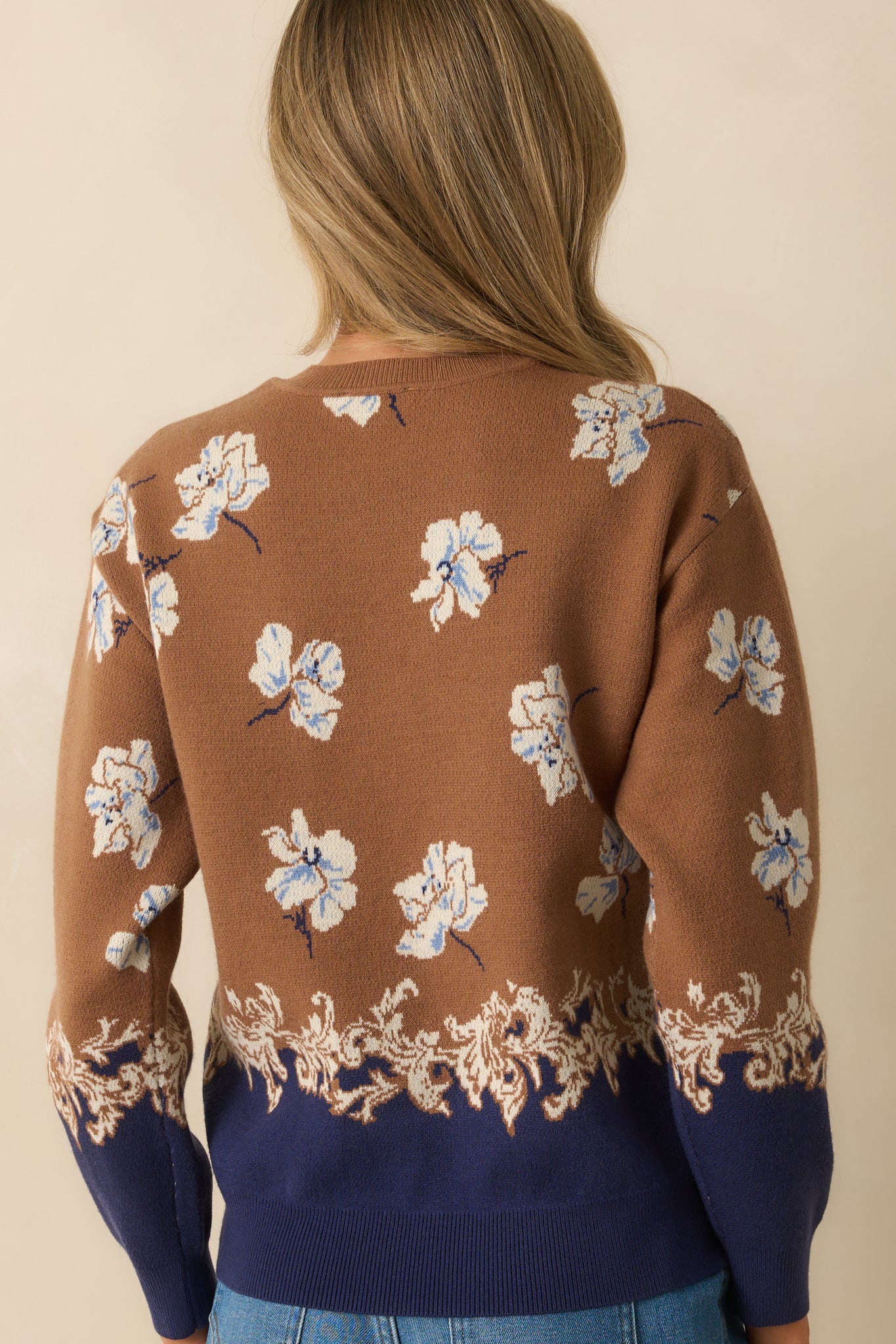 Rear view of the sweater with ribbed trims and consistent jacquard knit pattern.