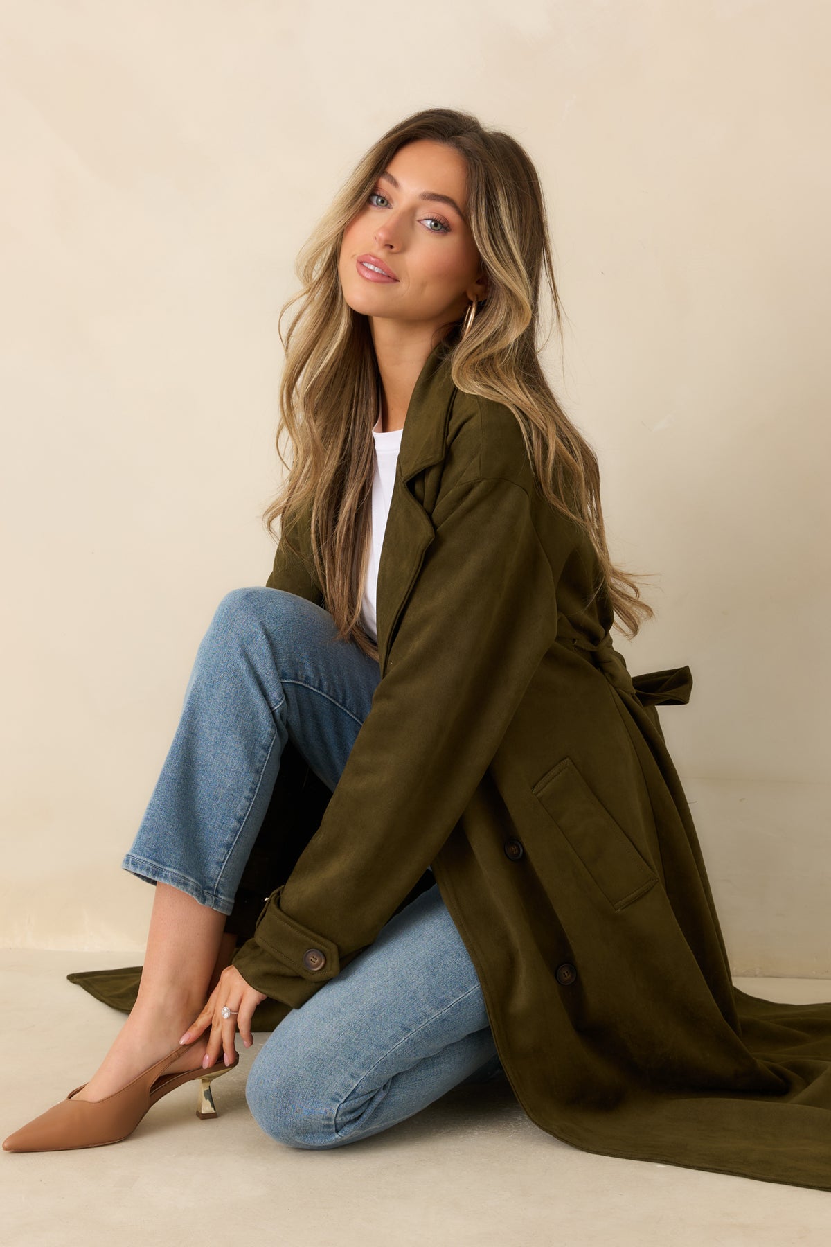 Tailored long coat with a matching waist sash and wide notched lapels.