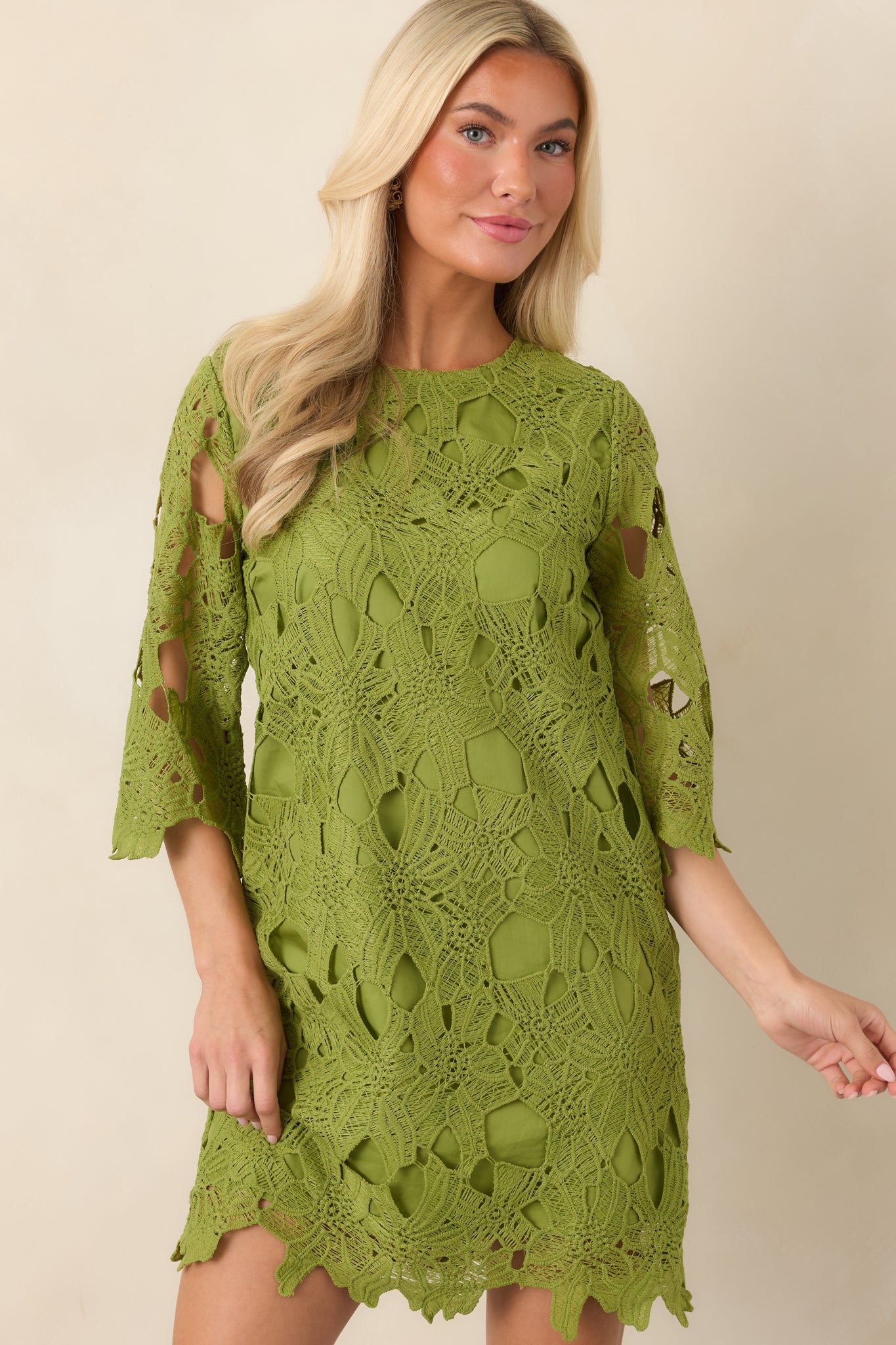 Mini dress detail showcasing the softly tailored construction, rounded neckline, and contrast between the sheer sleeves and lined body.