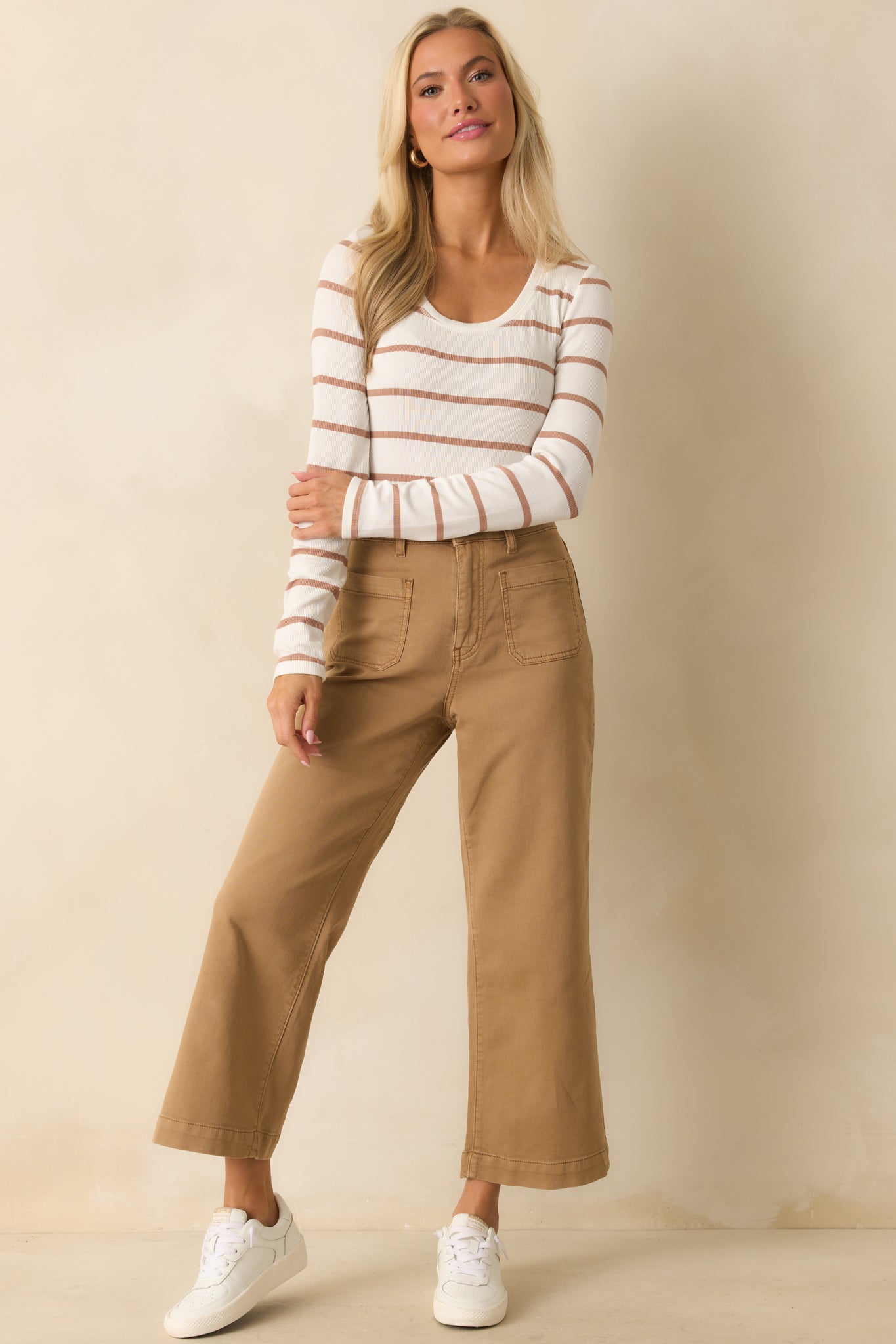 Tan brown high-rise pants with a wide-leg silhouette, cropped length, and front button and zipper closure.