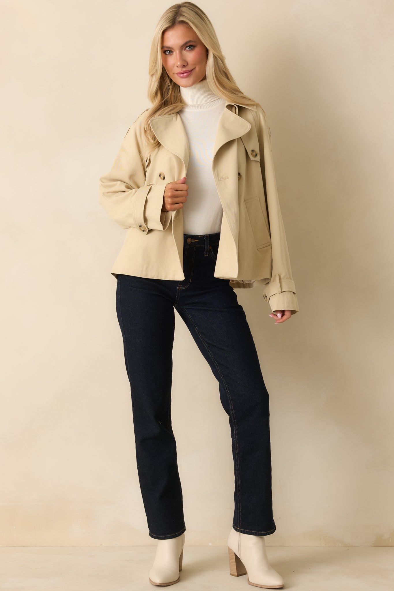 Tan cropped trench-style jacket showing double-breasted front and relaxed hip-length fit.
