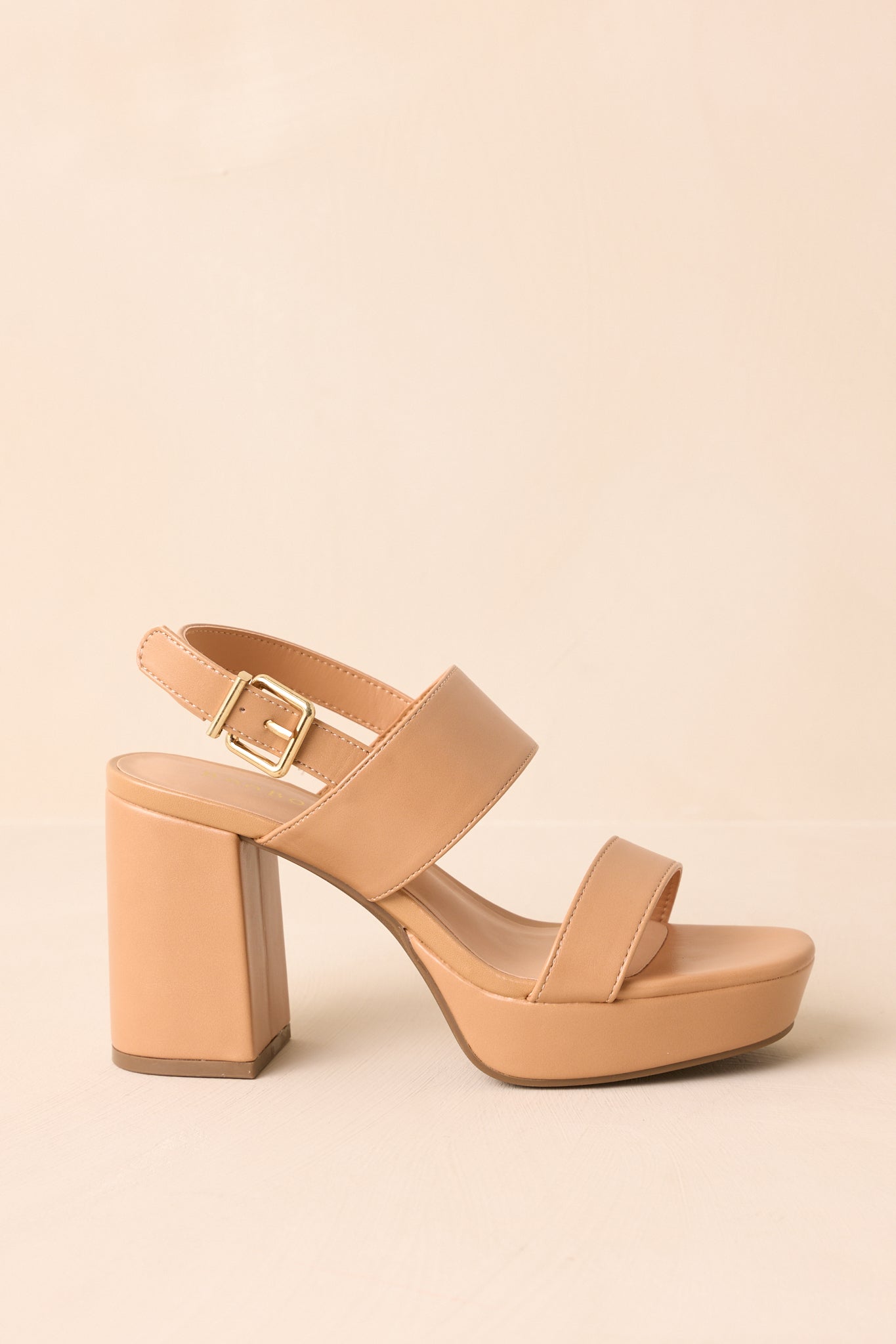Side view of the tan faux leather heels highlighting the platform sole and block heel height.