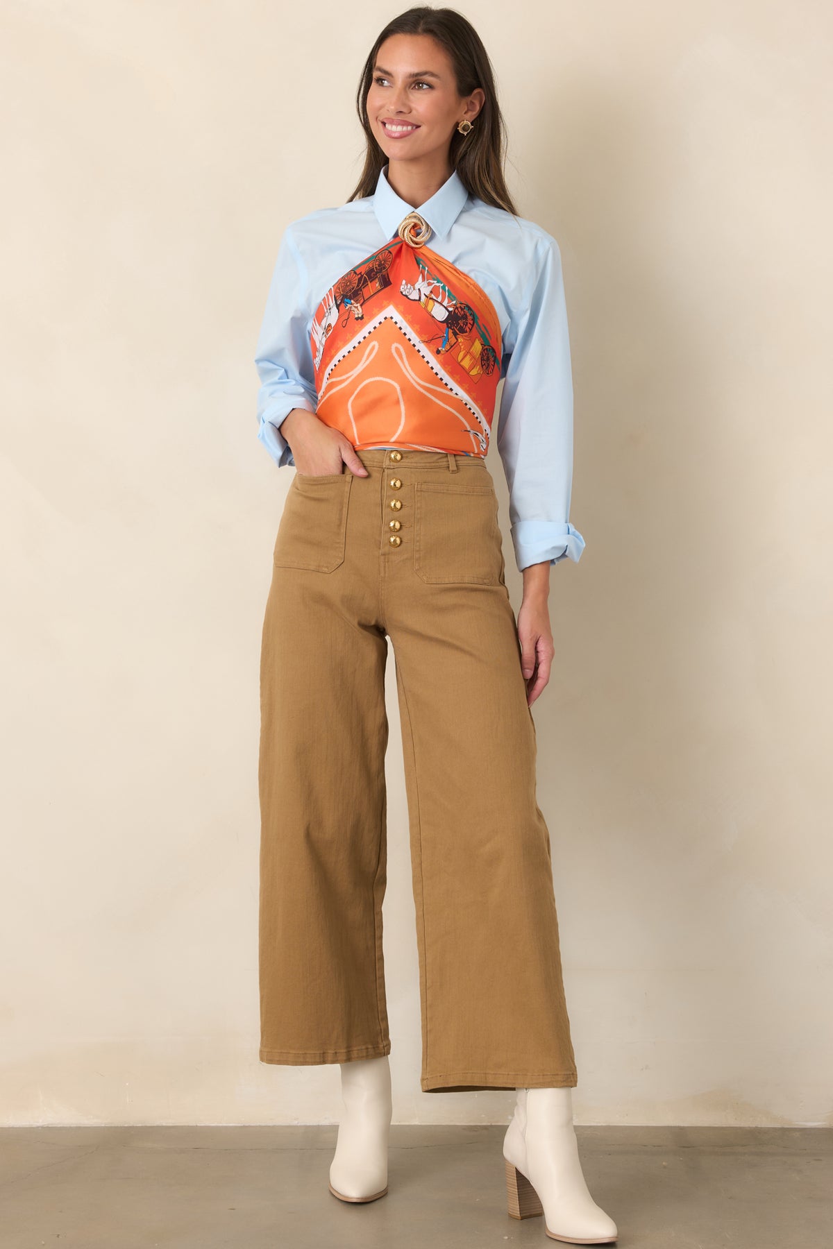 High-rise tan pants featuring a row of gold-tone buttons, front patch pockets, and relaxed cropped wide legs.