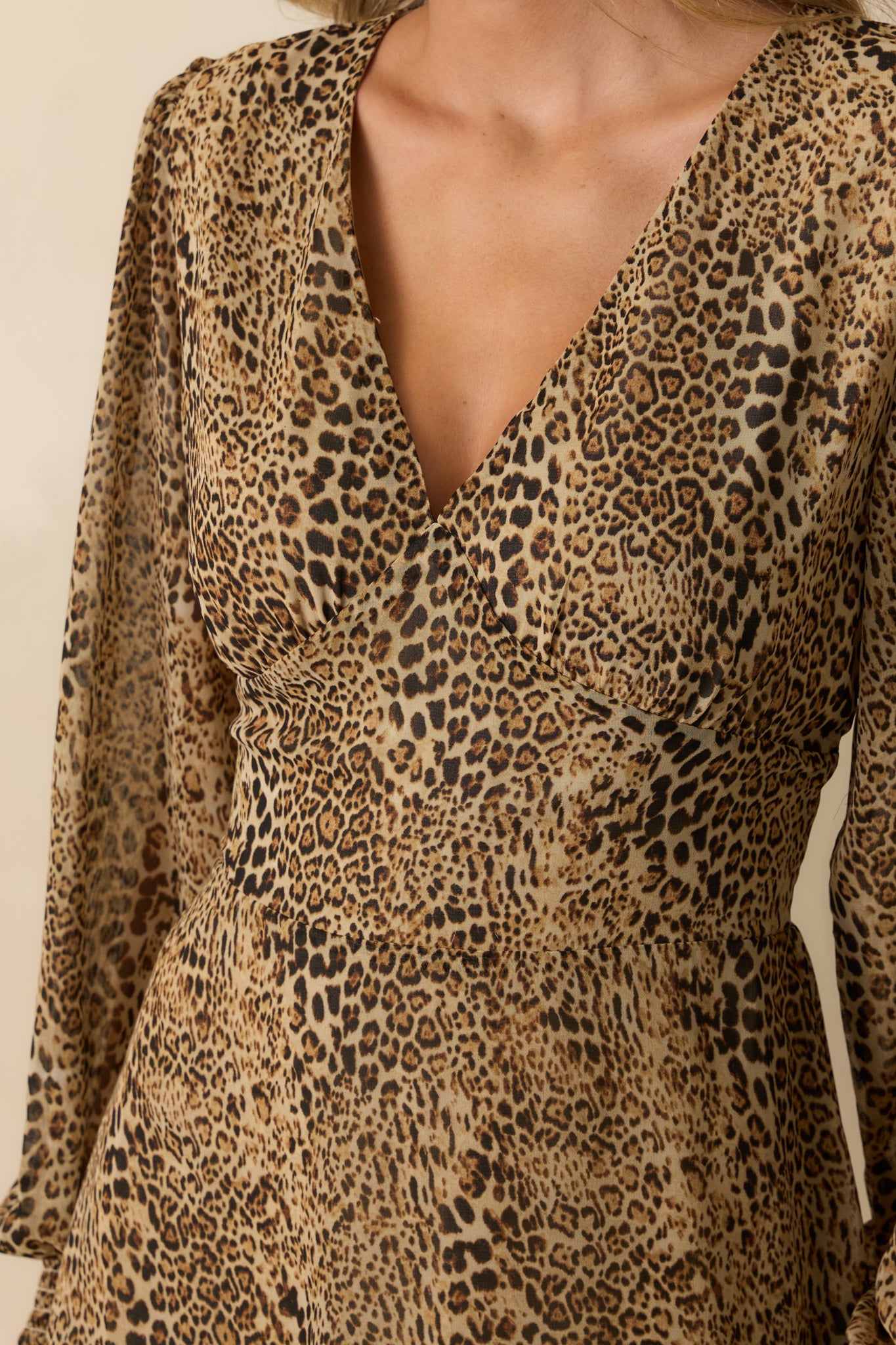 Detailed look at the tan leopard print chiffon and finely stitched ruffled hem.