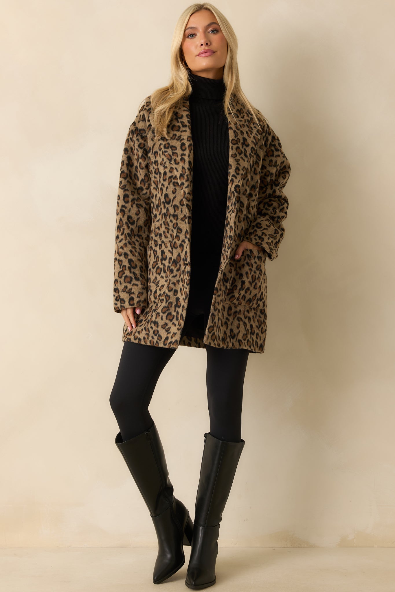 Tan leopard print longline coat with notched collar, long sleeves, and relaxed silhouette.