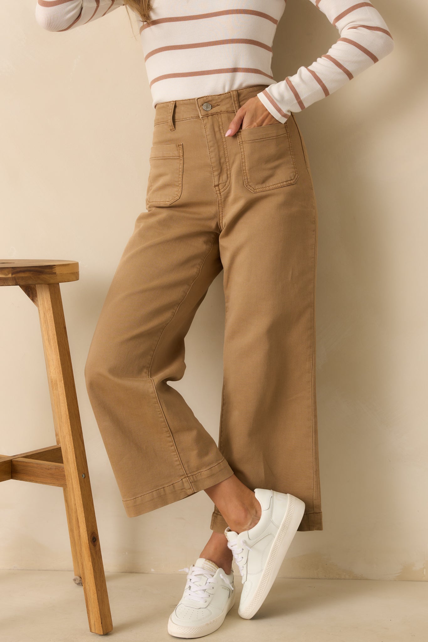 Cropped front view highlighting the button and zipper closure and belt loop details.