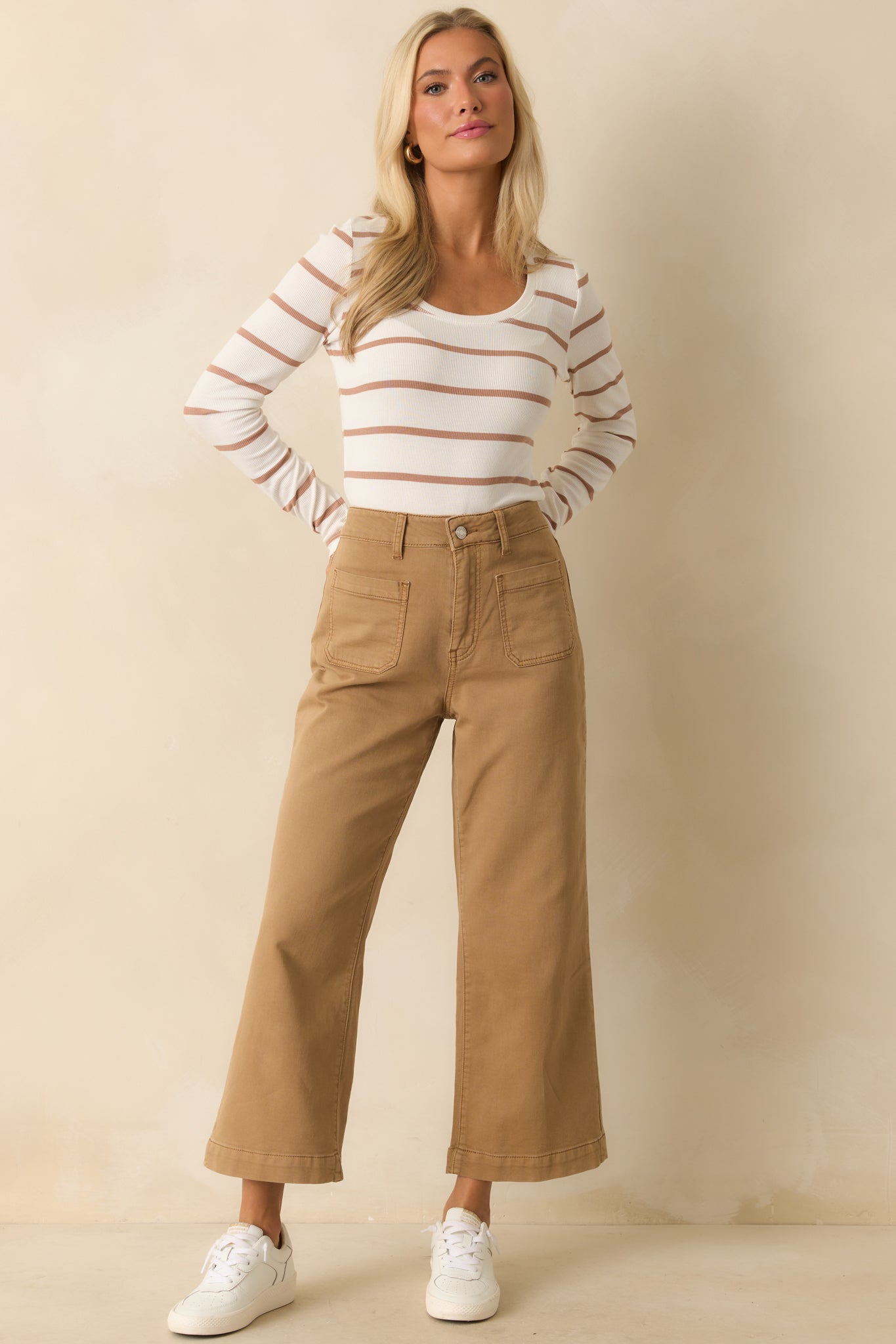 Wide-leg tan pants with high-rise waist and relaxed, cropped cut.