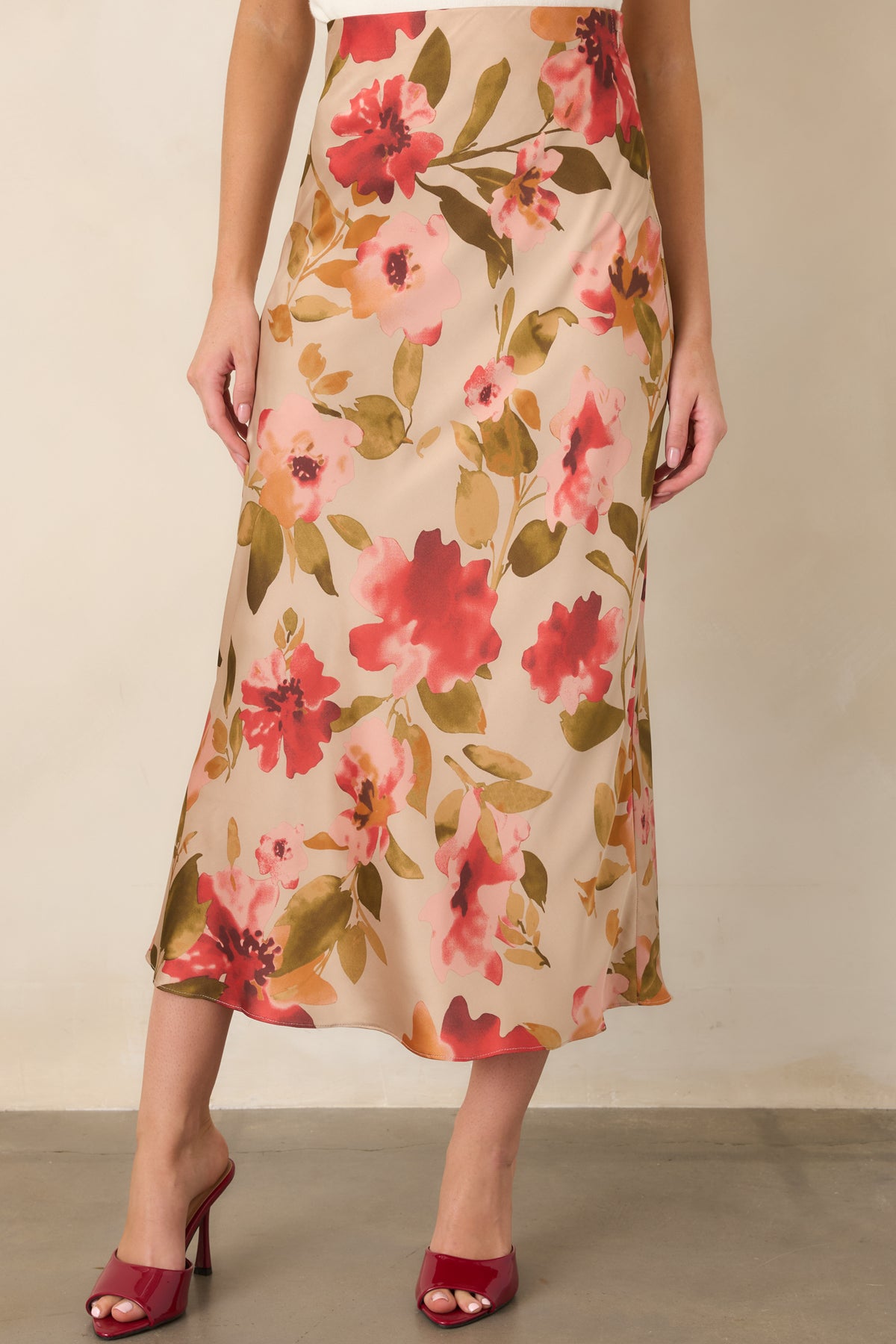 Tan maxi skirt showcasing its pink multicolor floral print and clean high-rise waistband.