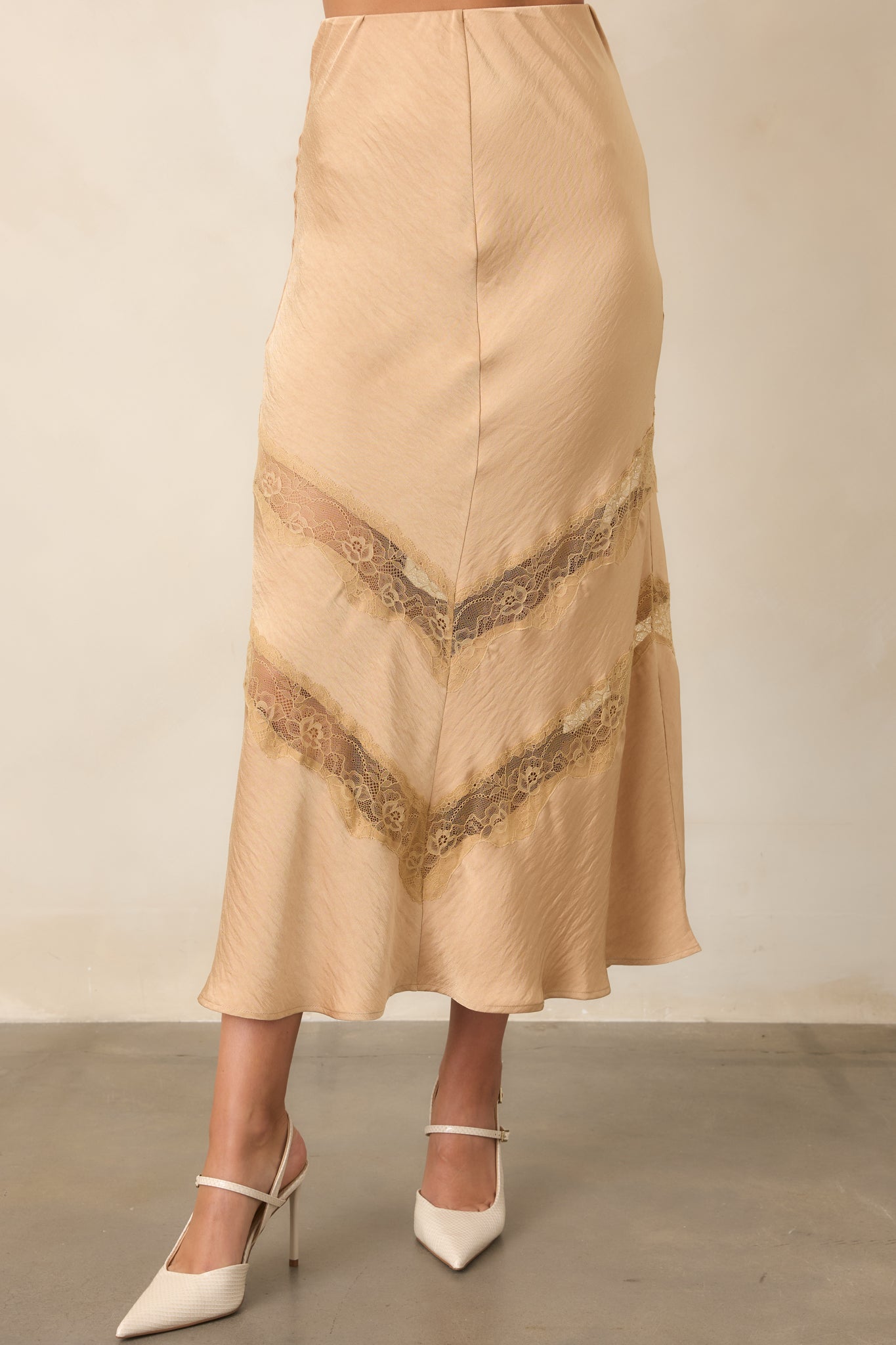 Tan skirt highlighting the delicate lace insets and softly textured fabric through the lower silhouette.