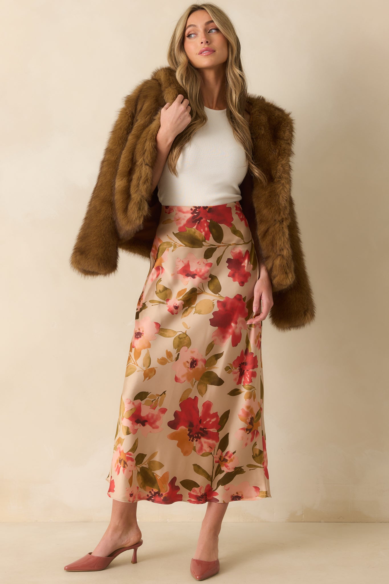 Flowing tan skirt featuring watercolor-inspired floral design and relaxed drape from the elastic waist.