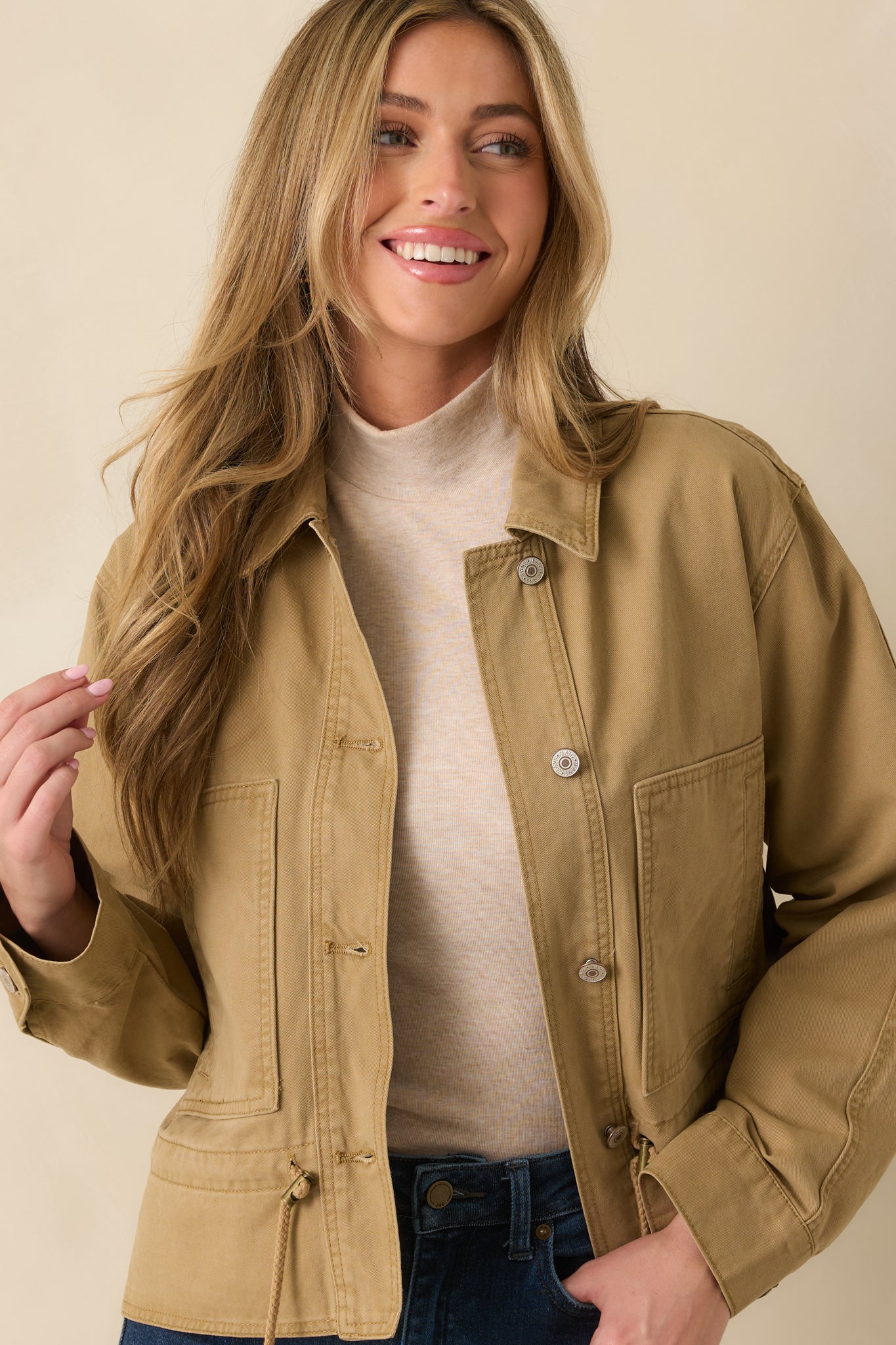 Tan utility jacket showing the patch pocket detailing and clean stitching.