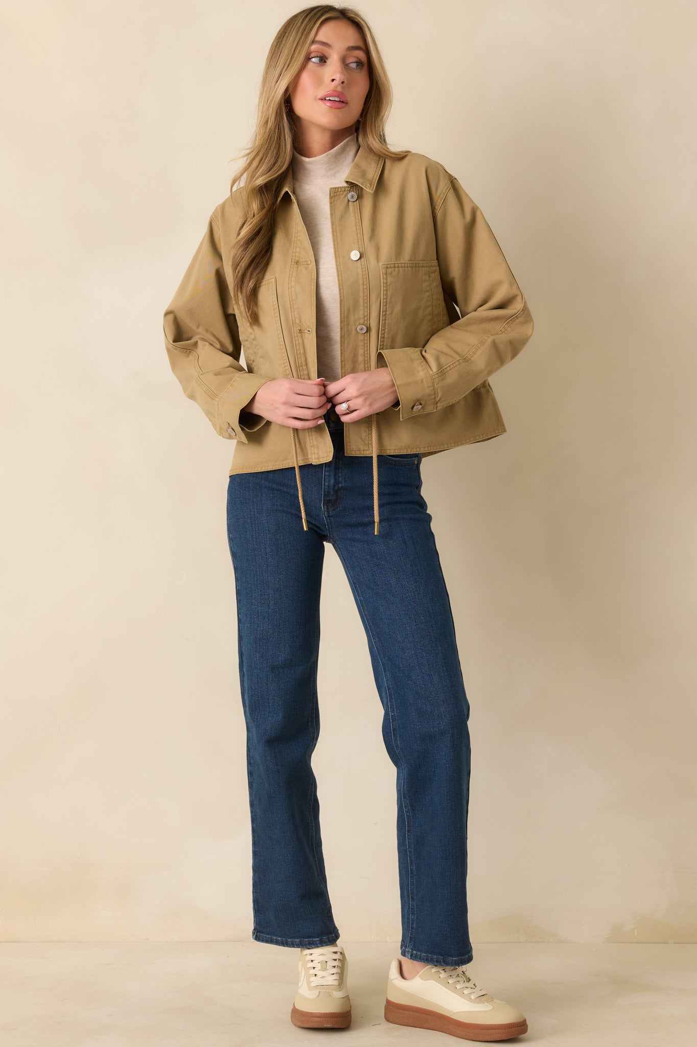 Tan utility jacket showing the patch pocket detailing and clean stitching.