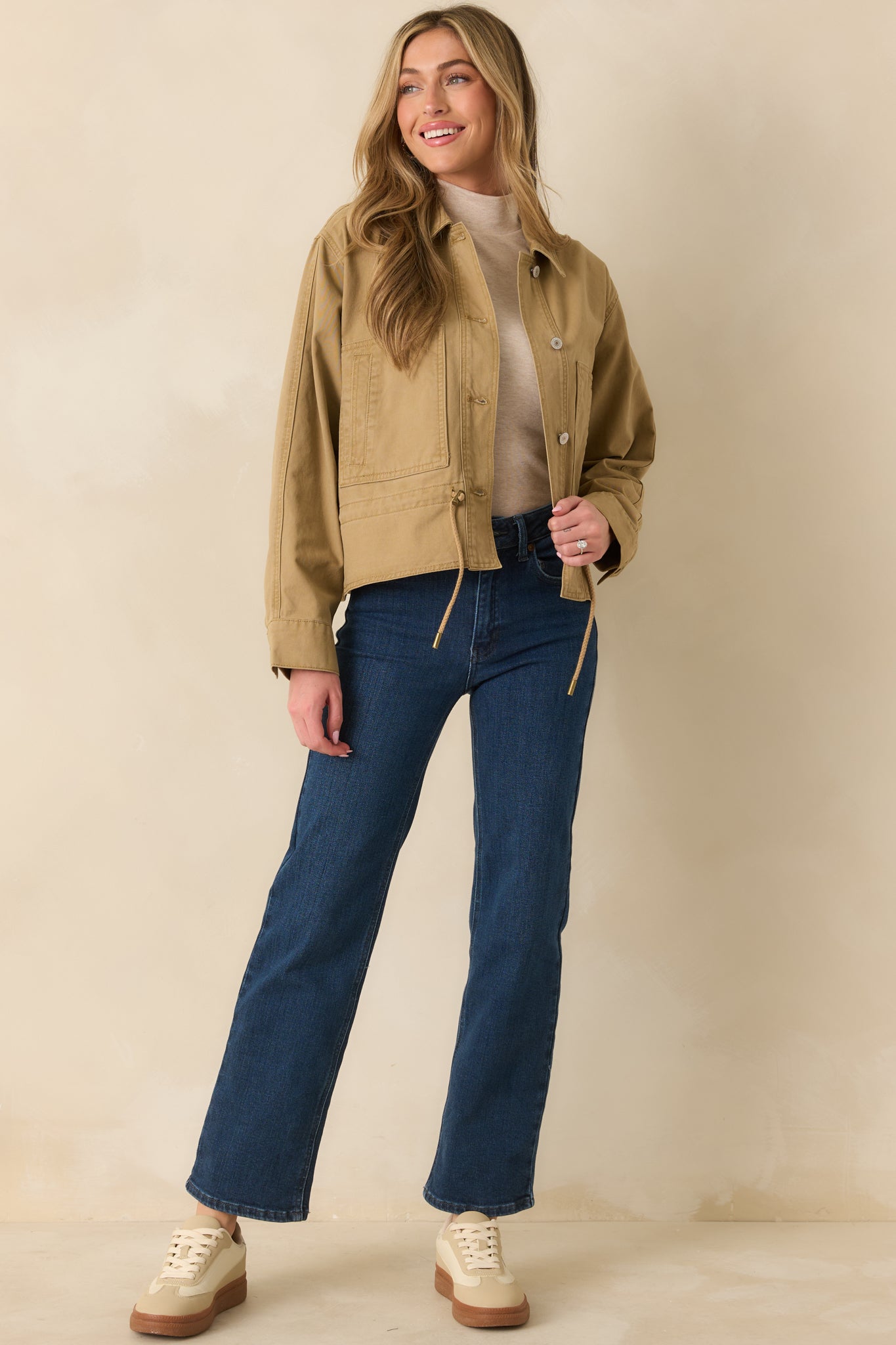 Tan utility jacket featuring the relaxed silhouette and adjustable drawcord hem.