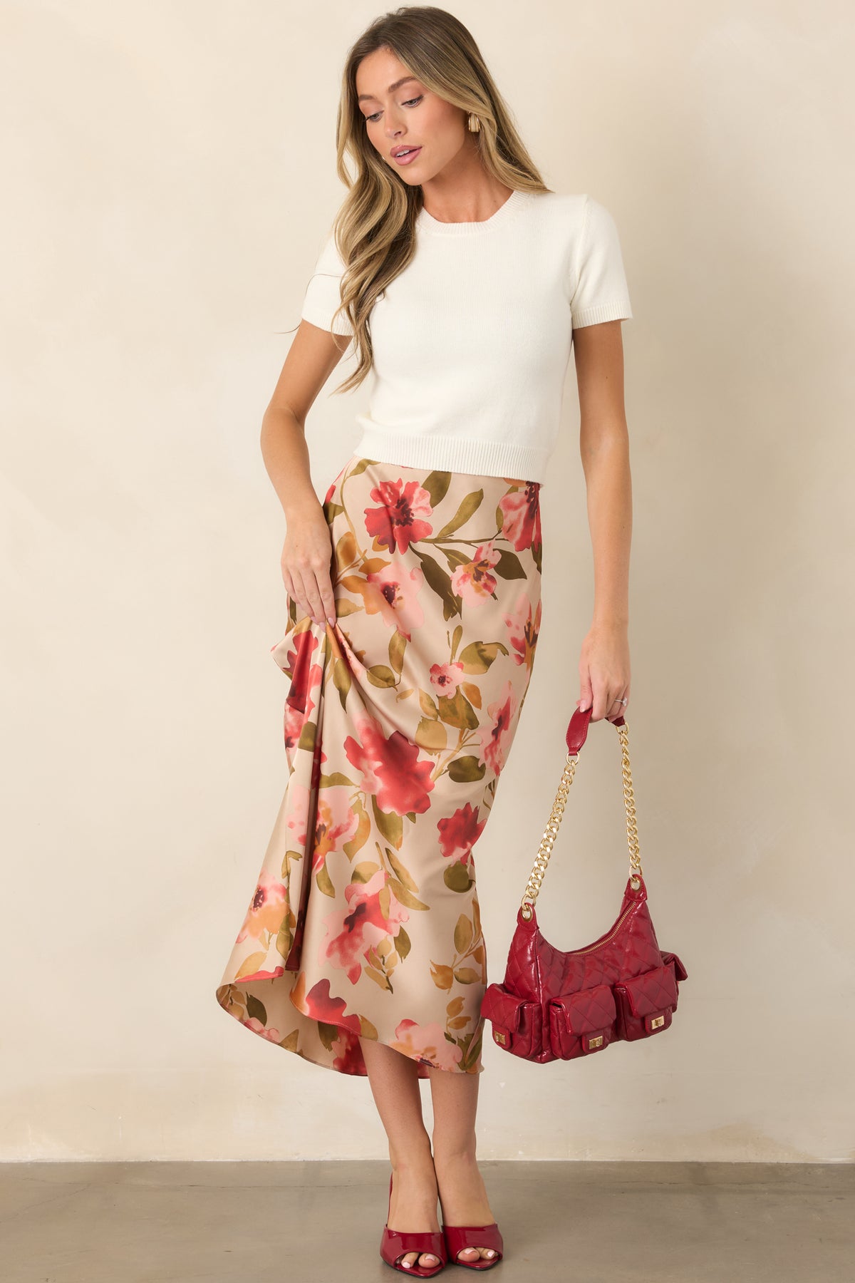 Tan floral maxi skirt with a watercolor-inspired print, elastic waistband, and flowing silhouette.