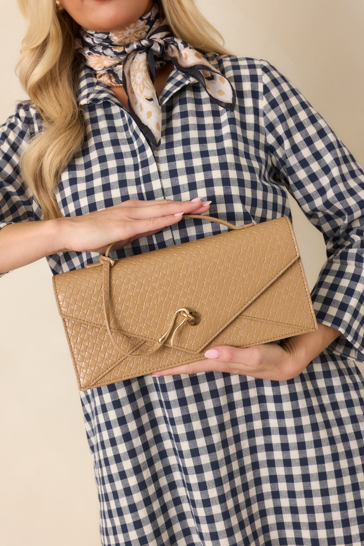 Textured woven tan clutch showcases a slender top handle and detachable gold-tone chain strap.