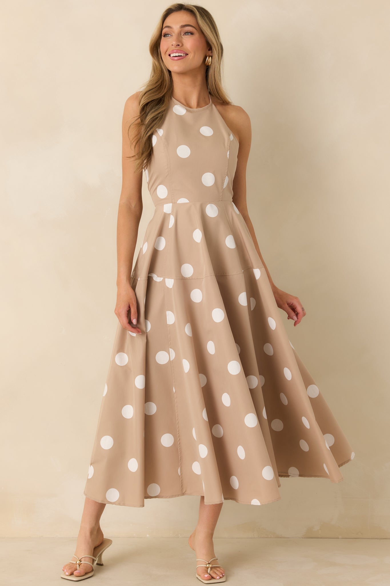Taupe halter maxi dress with allover white polka dots and soft, relaxed movement in the skirt.