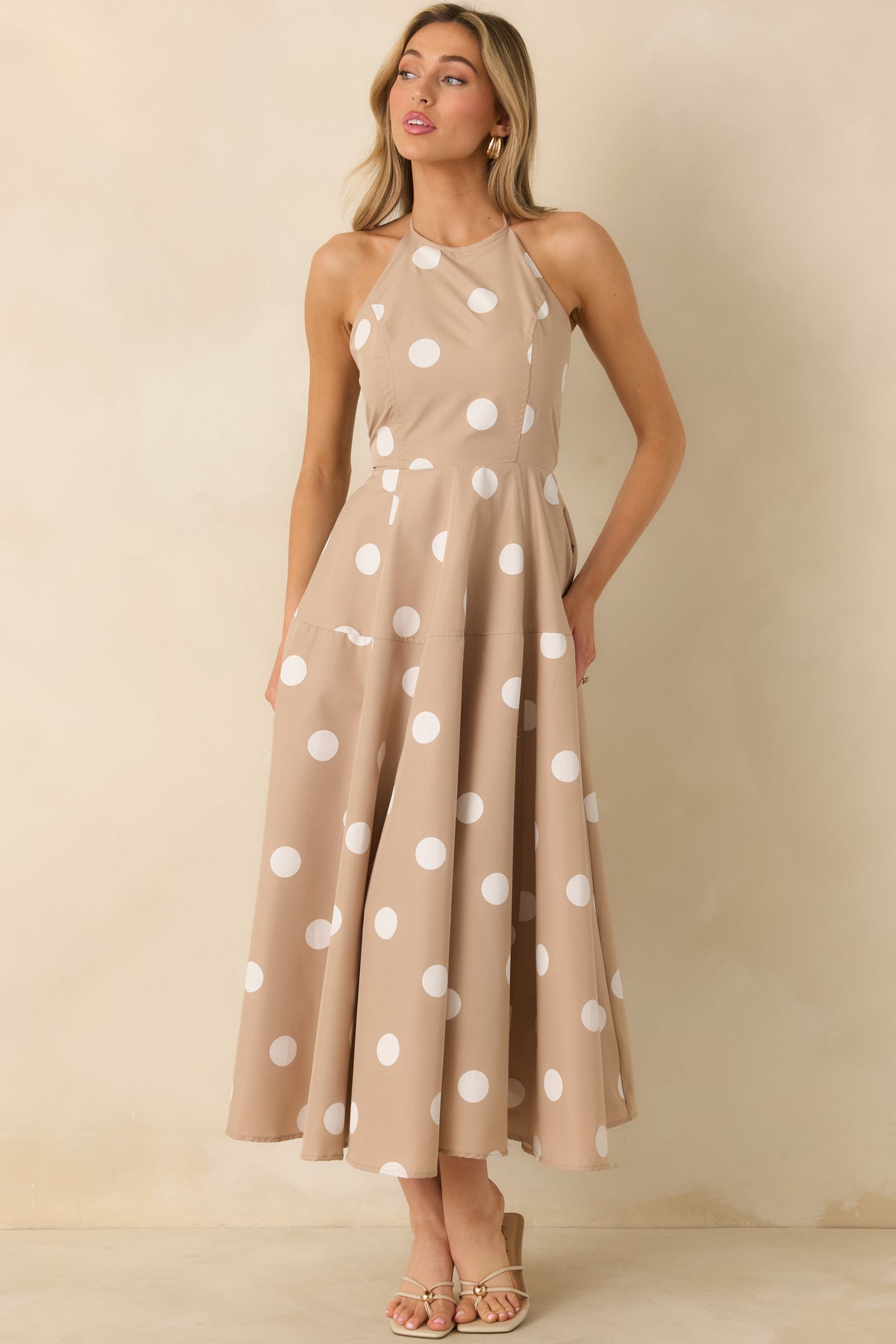 Taupe maxi dress showcasing a halter neckline, smocked back panel, and lightweight woven fabric.