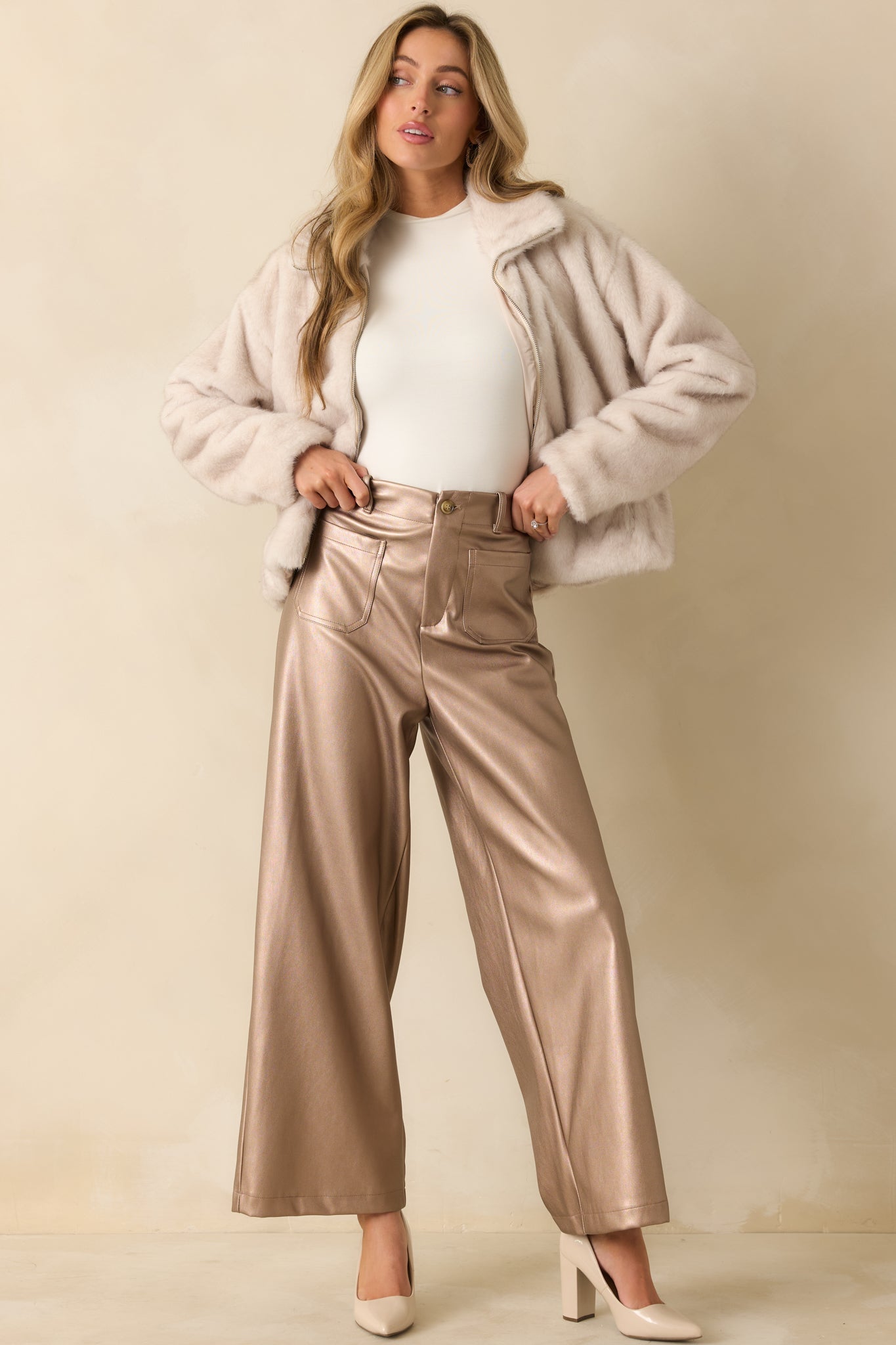 High-rise taupe metallic pants catching the light with a soft sheen and relaxed wide leg flow.