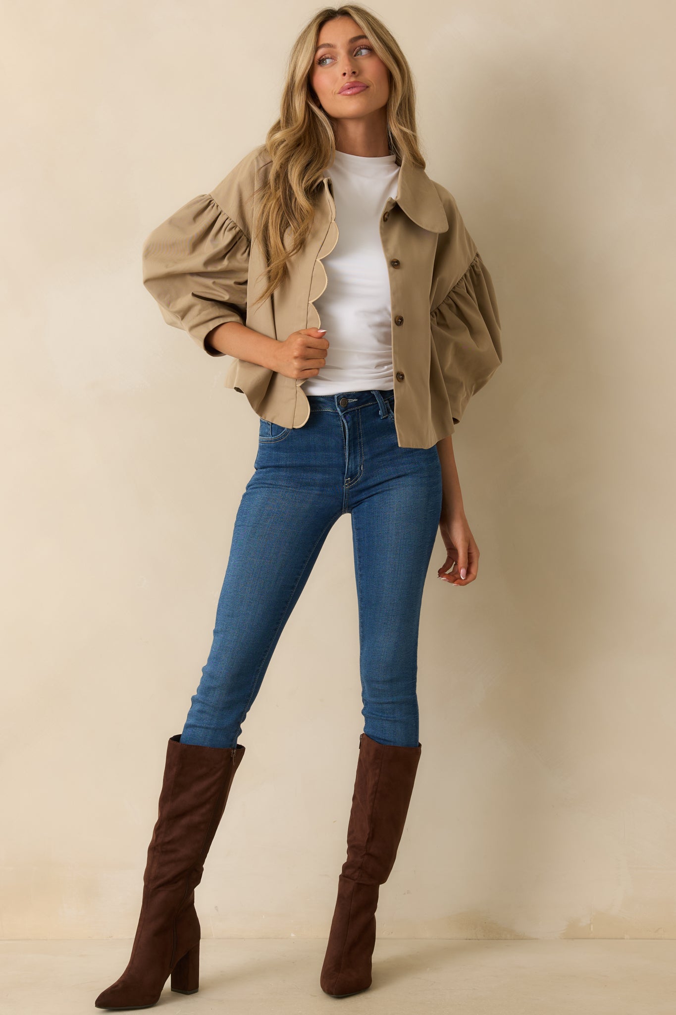 Taupe puff-sleeve jacket with scalloped edges and short, tailored silhouette.