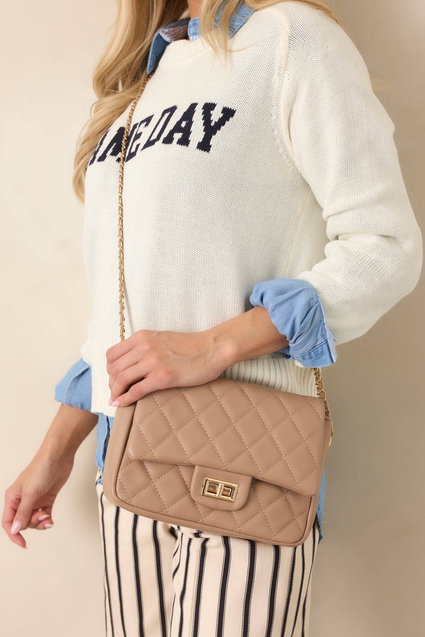 Taupe quilted handbag with a structured flap, front turn-lock closure, and classic chain strap for versatile shoulder or crossbody wear.
