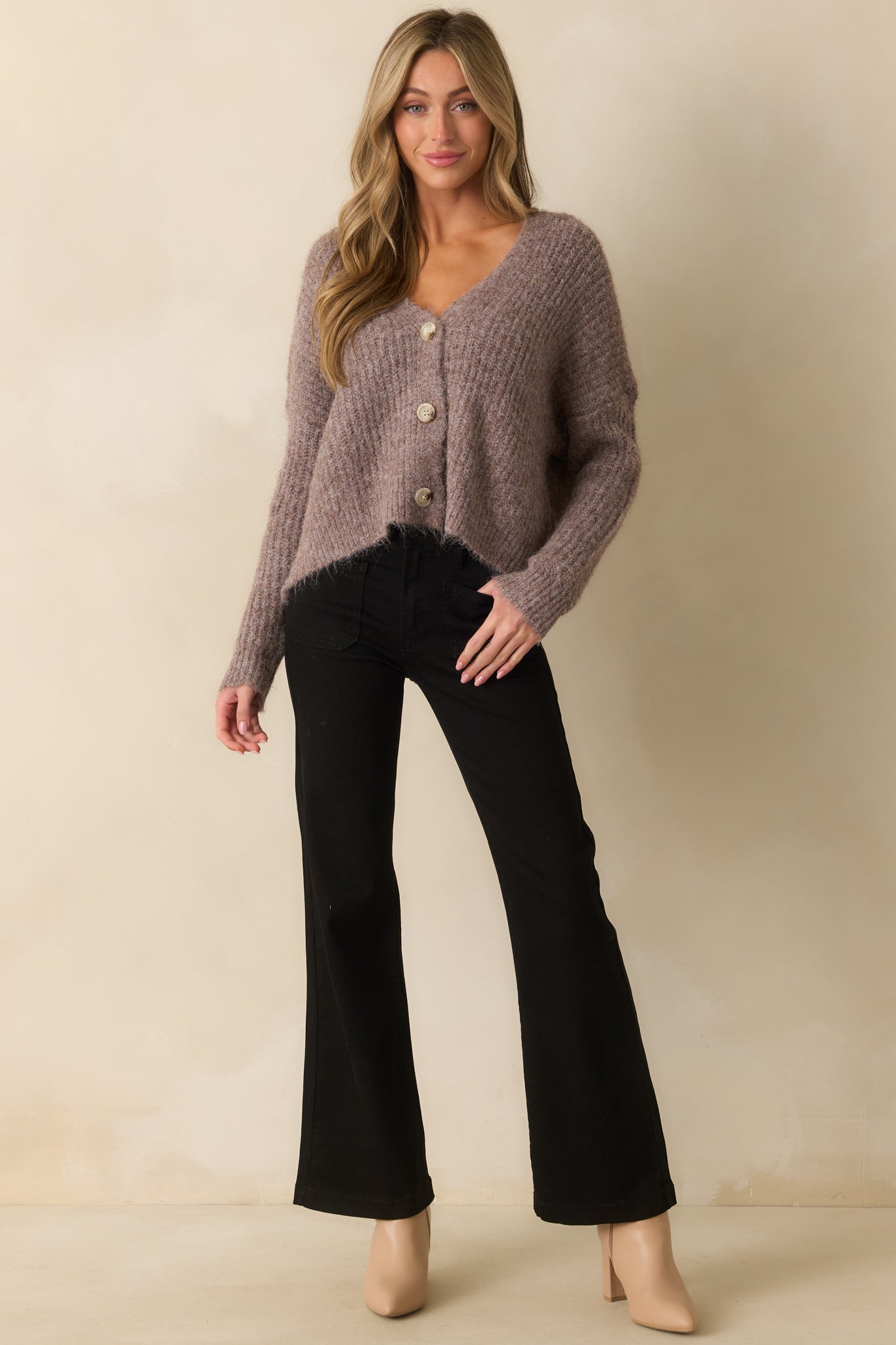Taupe ribbed knit cardigan with deep v-neckline, long sleeves, and relaxed fit.