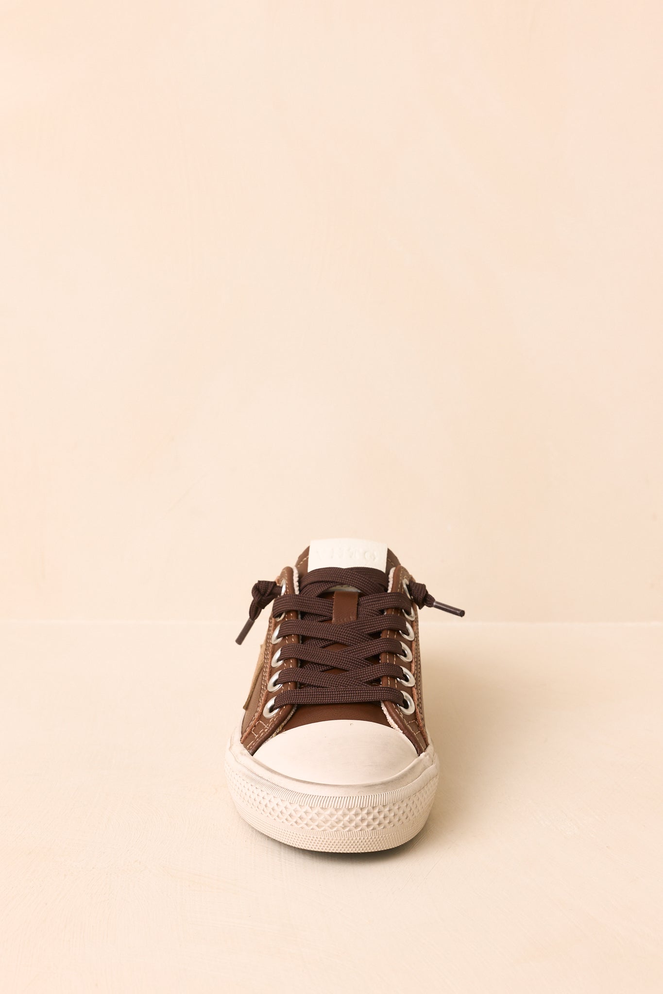 Taupe suede star detailing adds a signature touch to these vintage-inspired low-top sneakers.