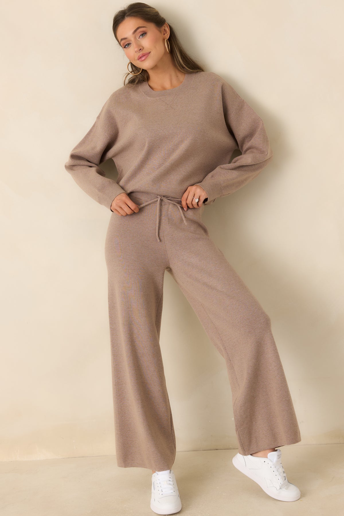 Soft taupe sweater with dropped shoulders, loose sleeves, and ribbed neckline and hem.