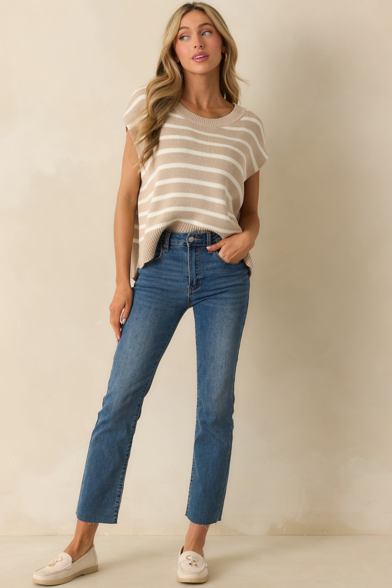 Taupe sweater vest displayed front facing, highlighting the oversized silhouette, cap sleeves, and subtle horizontal stripes.