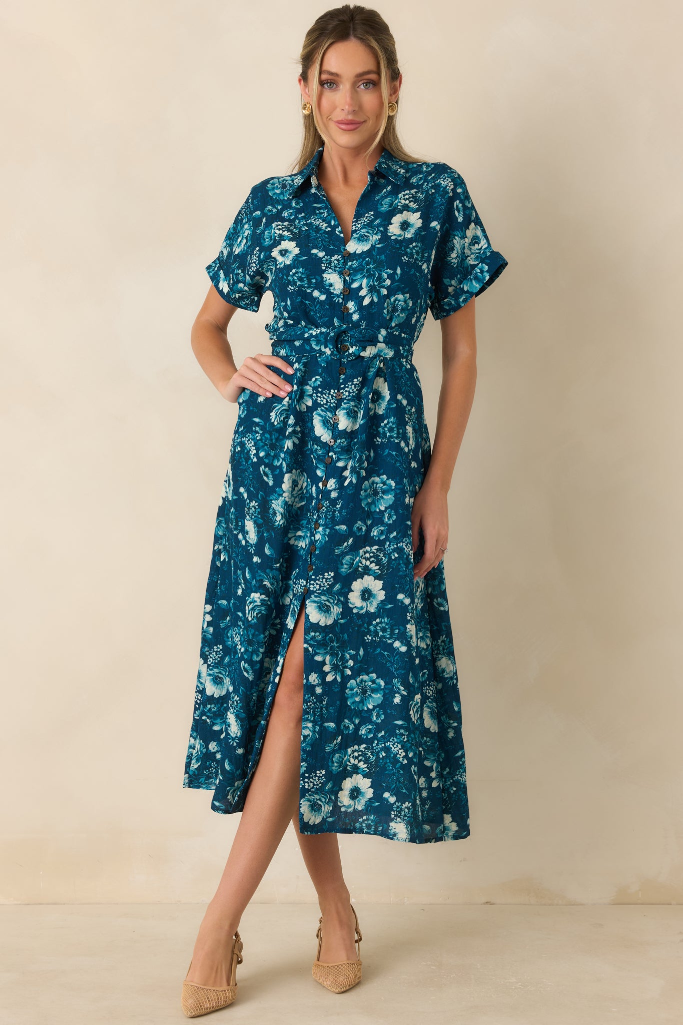 Floral teal dress featuring a structured collar, functional buttons, belted waist, and easy fit.