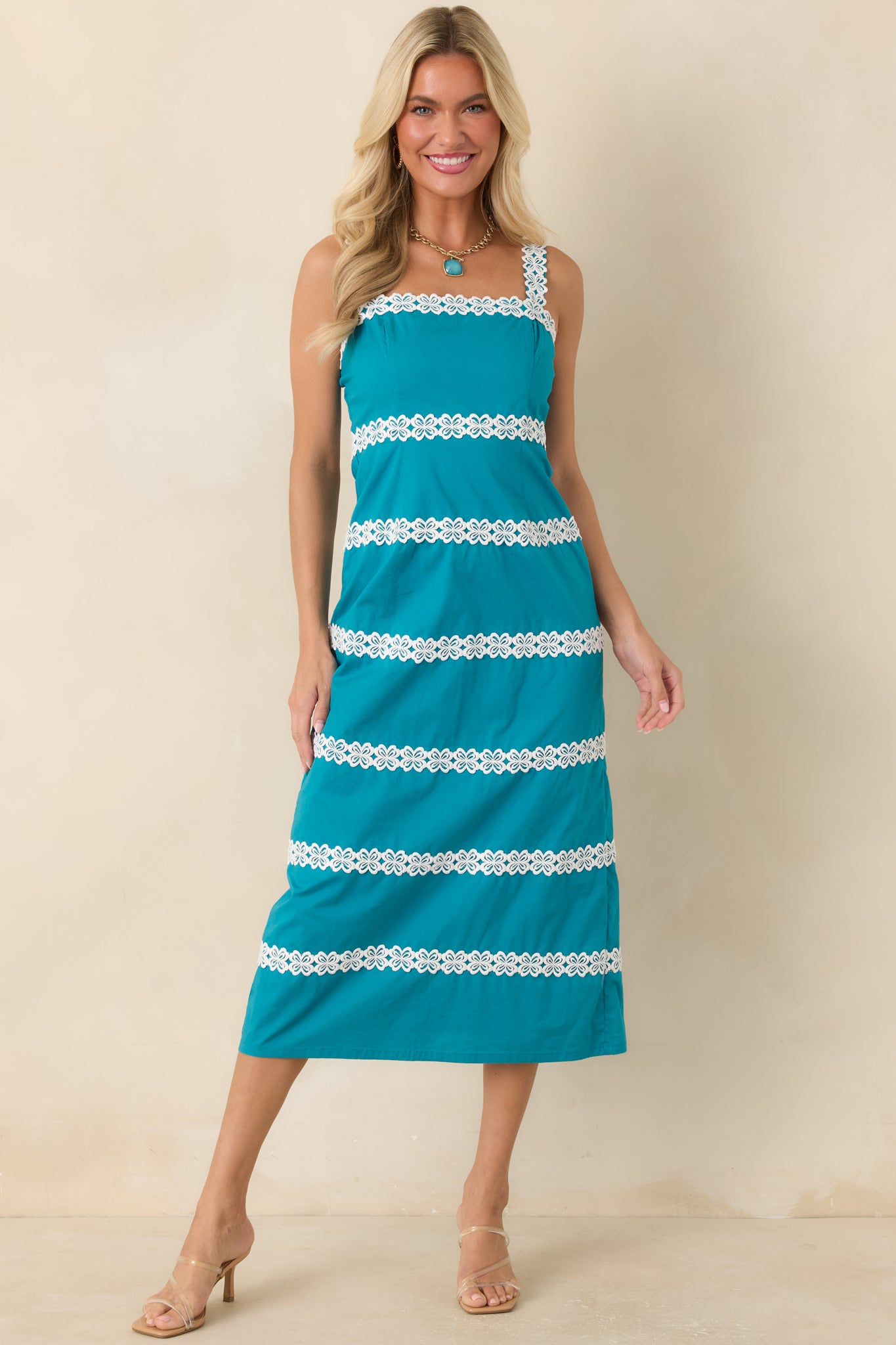 Teal dress with a flattering fitted bodice, lace-trimmed straps, and a refined vintage aesthetic.