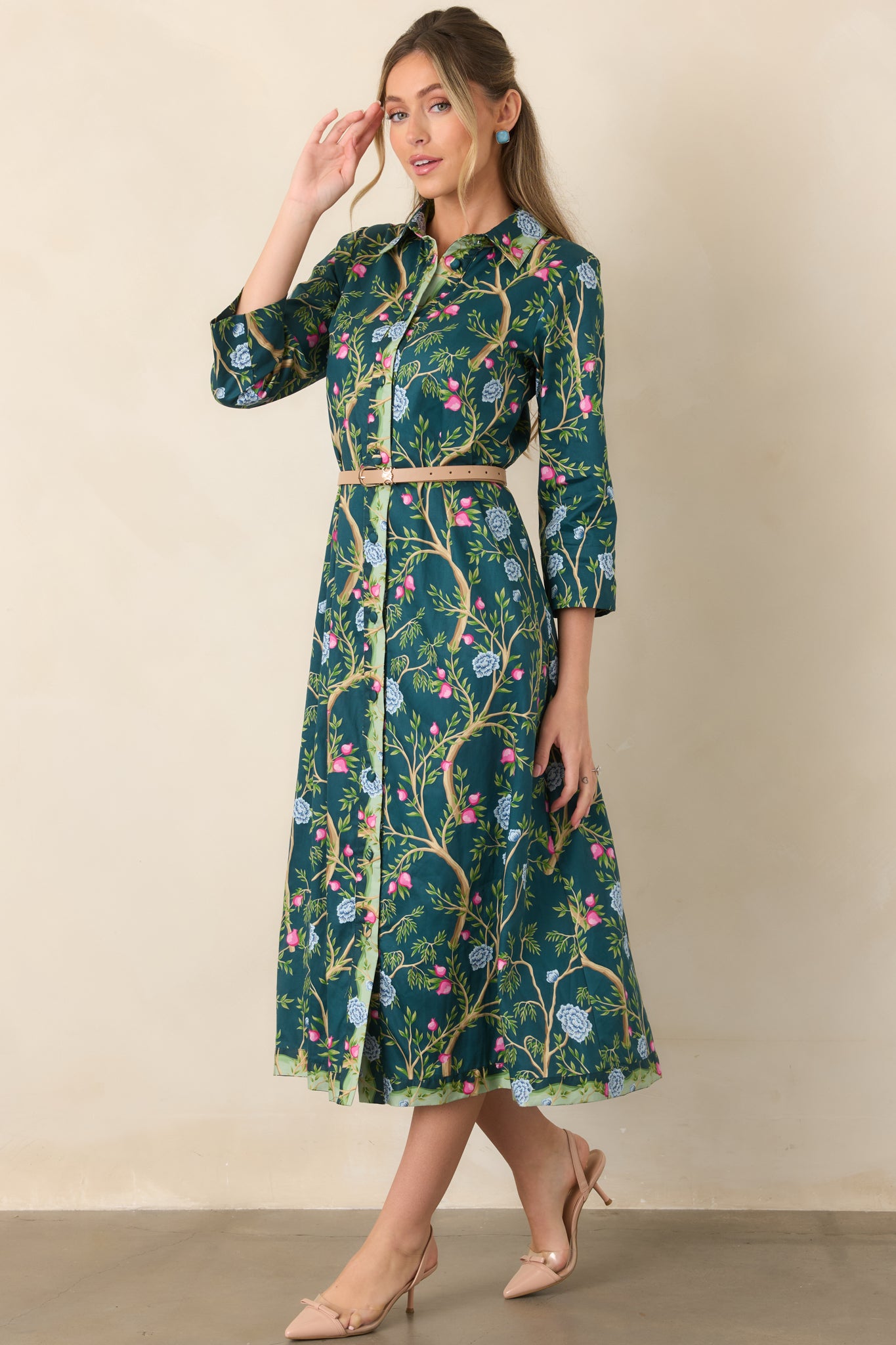 Teal floral dress with winding tan branches, colorful leafy blooms, a structured collar, three-quarter sleeves, and a contrasting light green floral button placket.