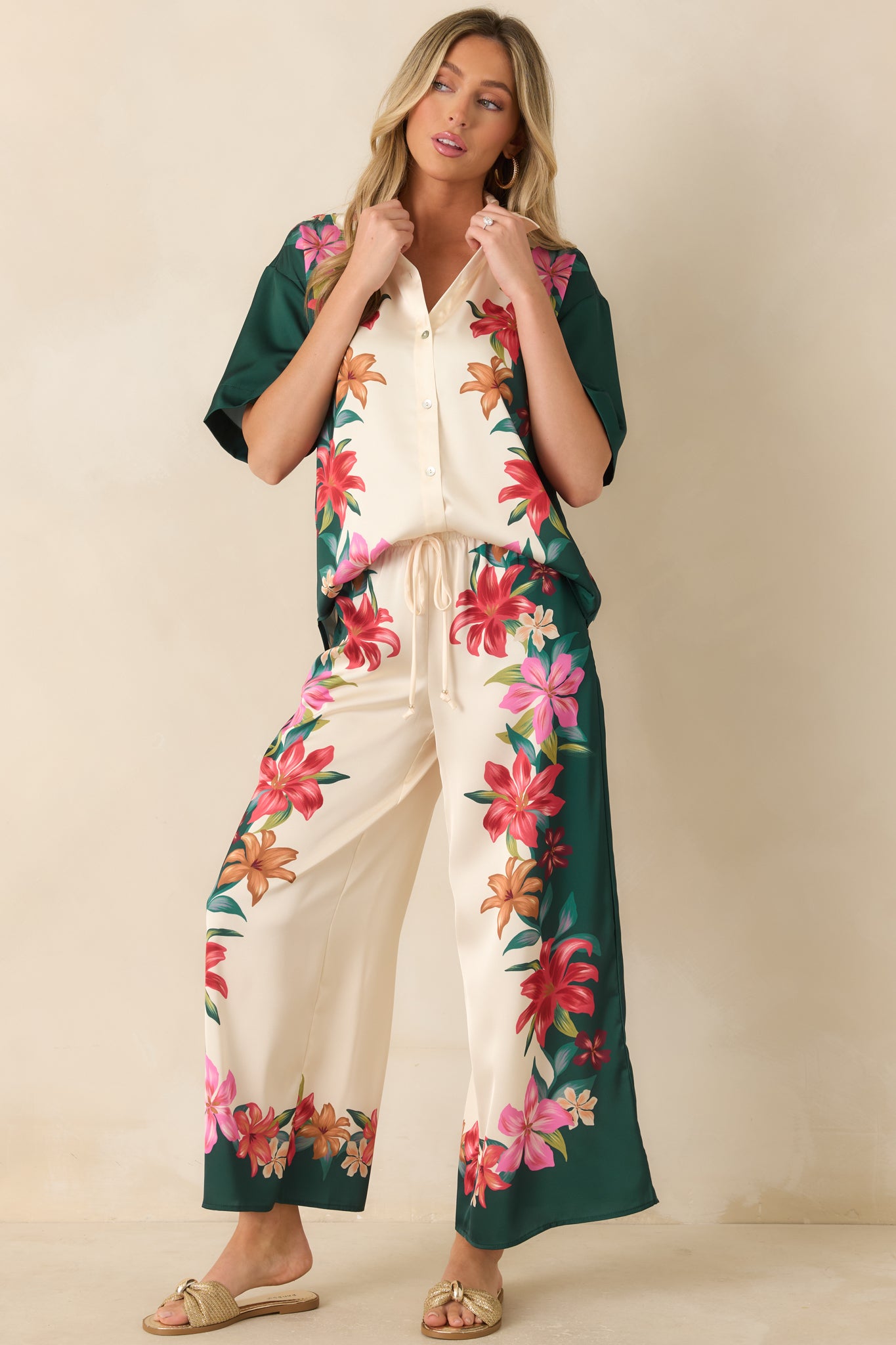 Teal floral satin button-front top with a relaxed silhouette, vacation-inspired print, and classic collared neckline.