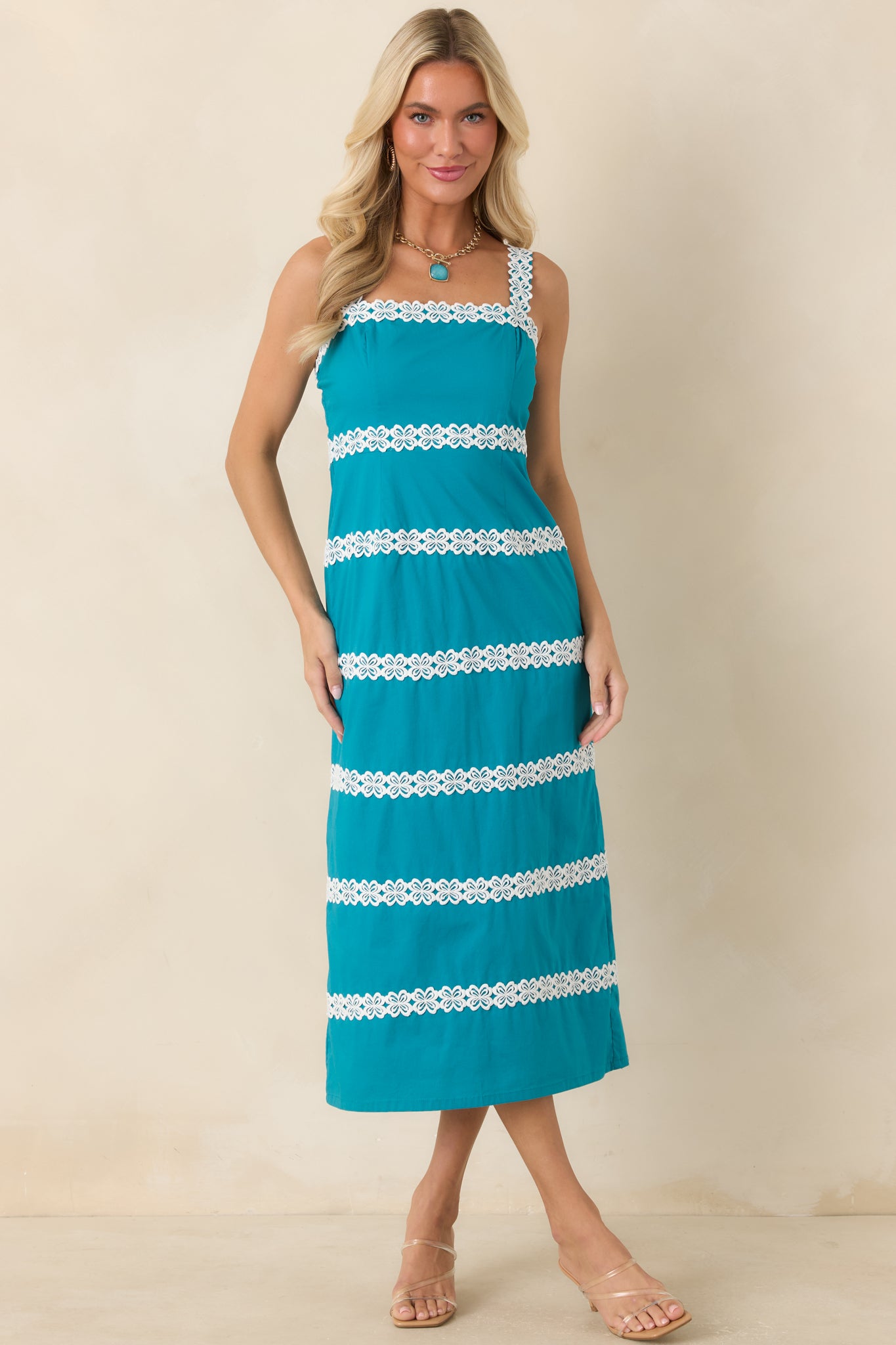 Teal midi dress featuring ivory floral lace panels, a square neckline, and a fitted silhouette.