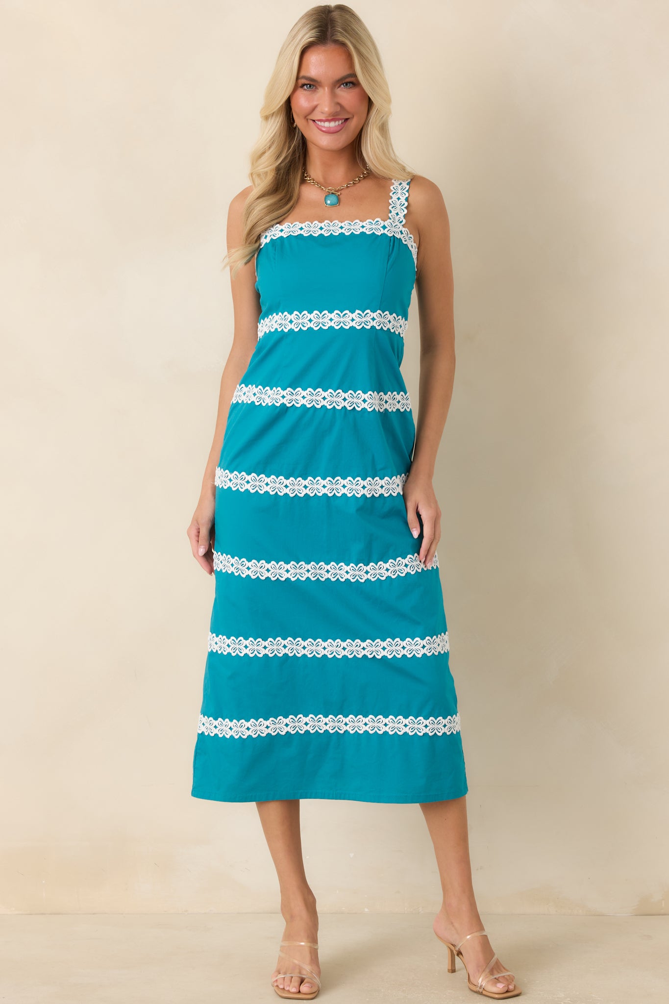 Teal midi dress featuring a streamlined silhouette, delicate ivory lace bands, and a timeless square neckline.