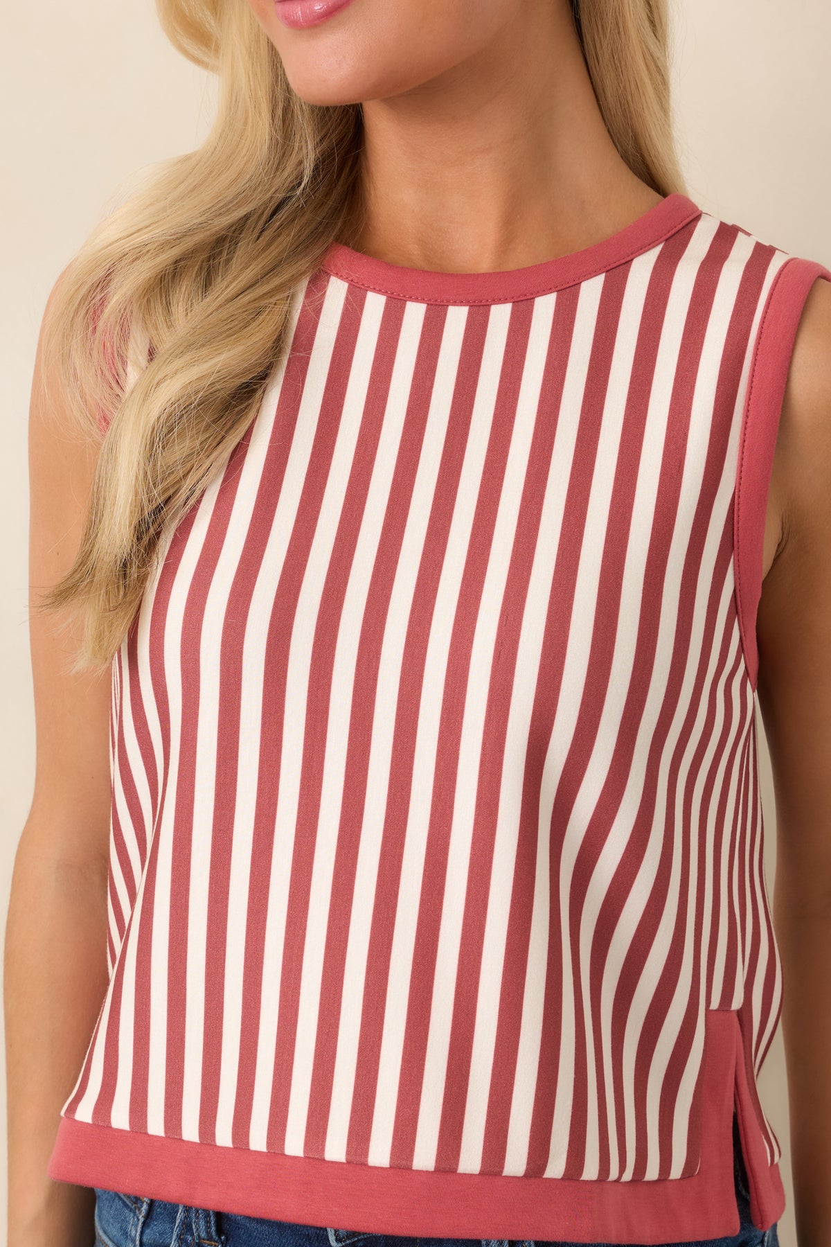 Detail view highlighting the terracotta and ivory vertical stripe pattern, rounded neckline, and contrasting terracotta trim.
