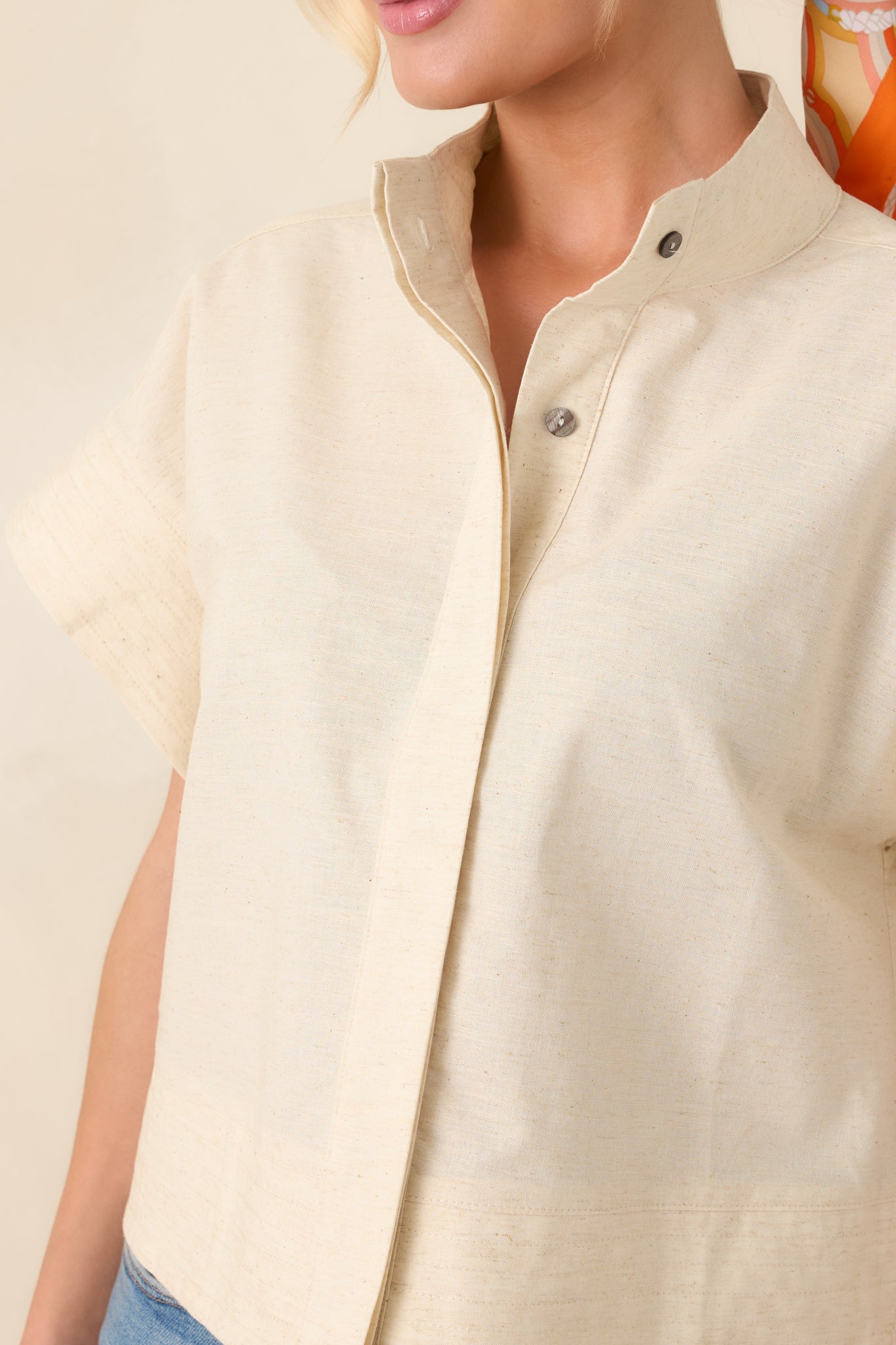 Textured cotton linen blend with concealed button placket and wide cuffed sleeve.
