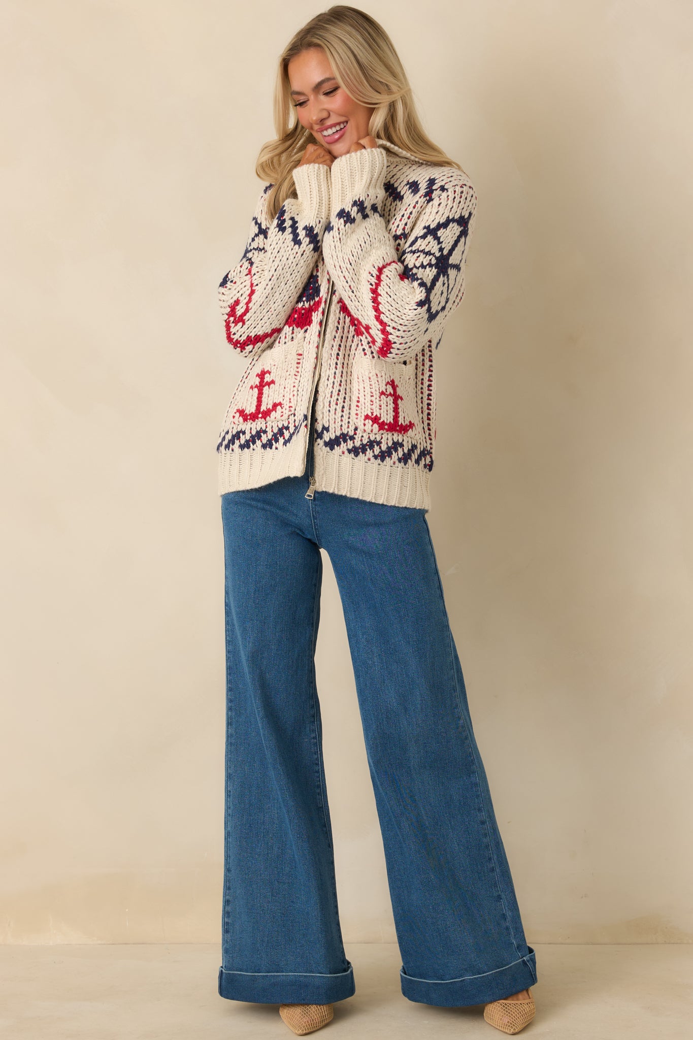 Full body front view of textured ivory knit jacket featuring red and navy nautical designs and ribbed cuffs and hem.