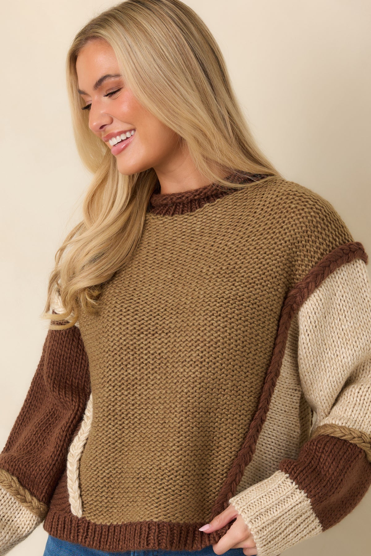 Long sleeves combine contrasting knit textures with chocolate brown ribbed cuffs.