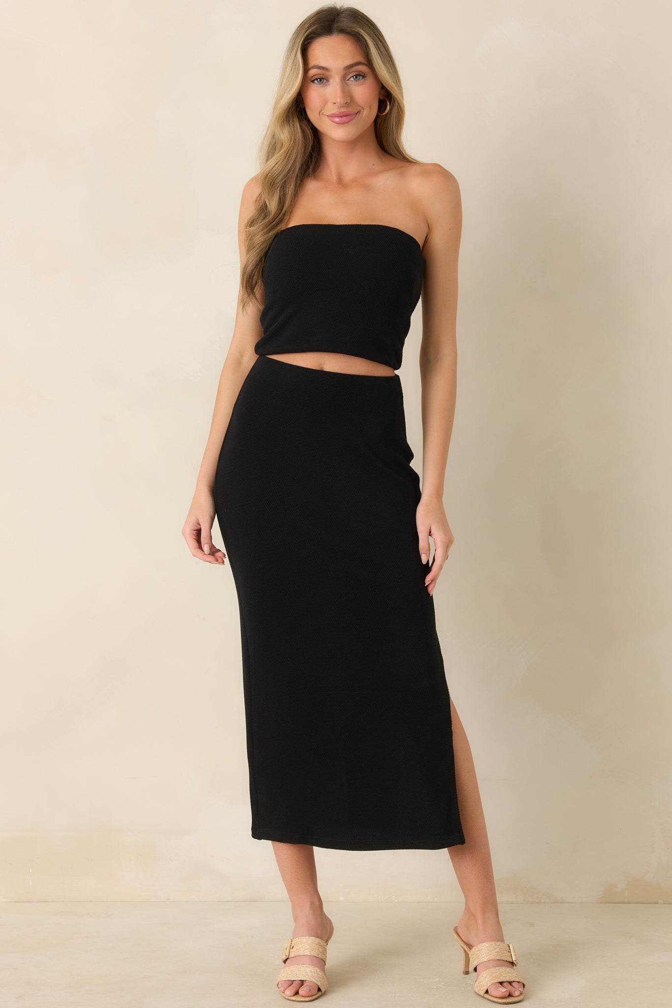 Textured midi skirt with pull-on design, body-hugging fit, and subtle side slit detail.