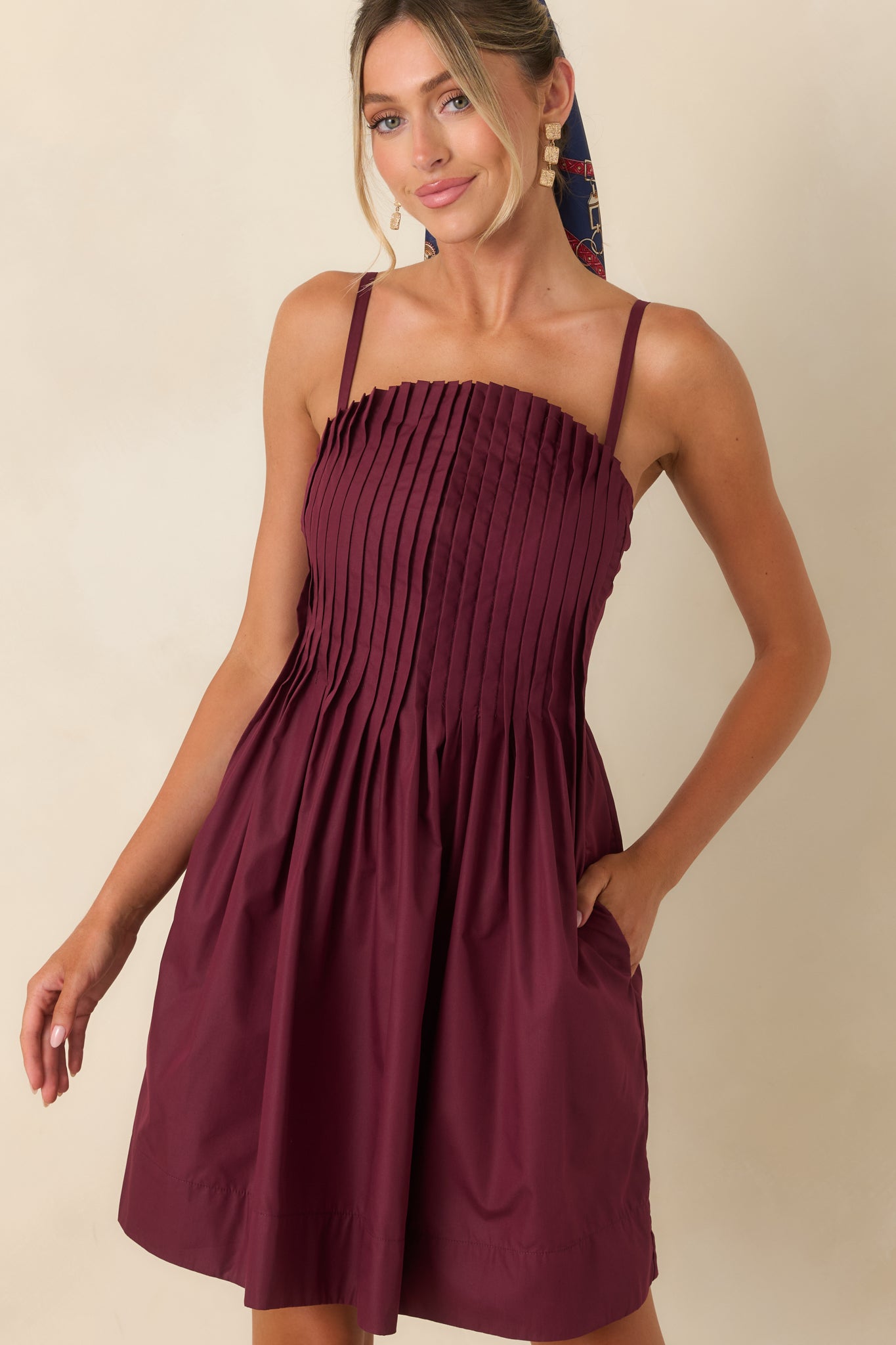 Mini dress showcasing the textured pleats, lightweight woven fabric, and flattering structured neckline.