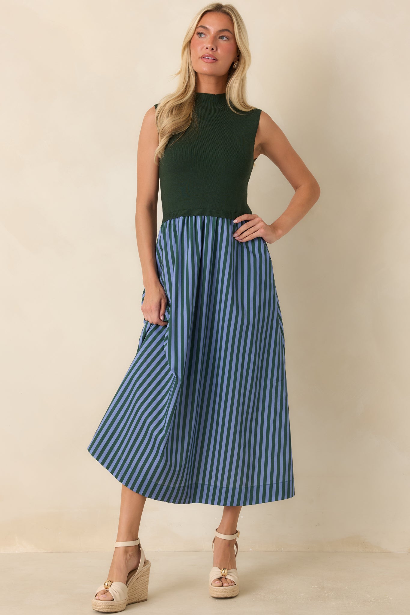 Textured sleeveless dress featuring a fitted upper silhouette, mock neckline, and a full midi skirt with contrasting stripes.