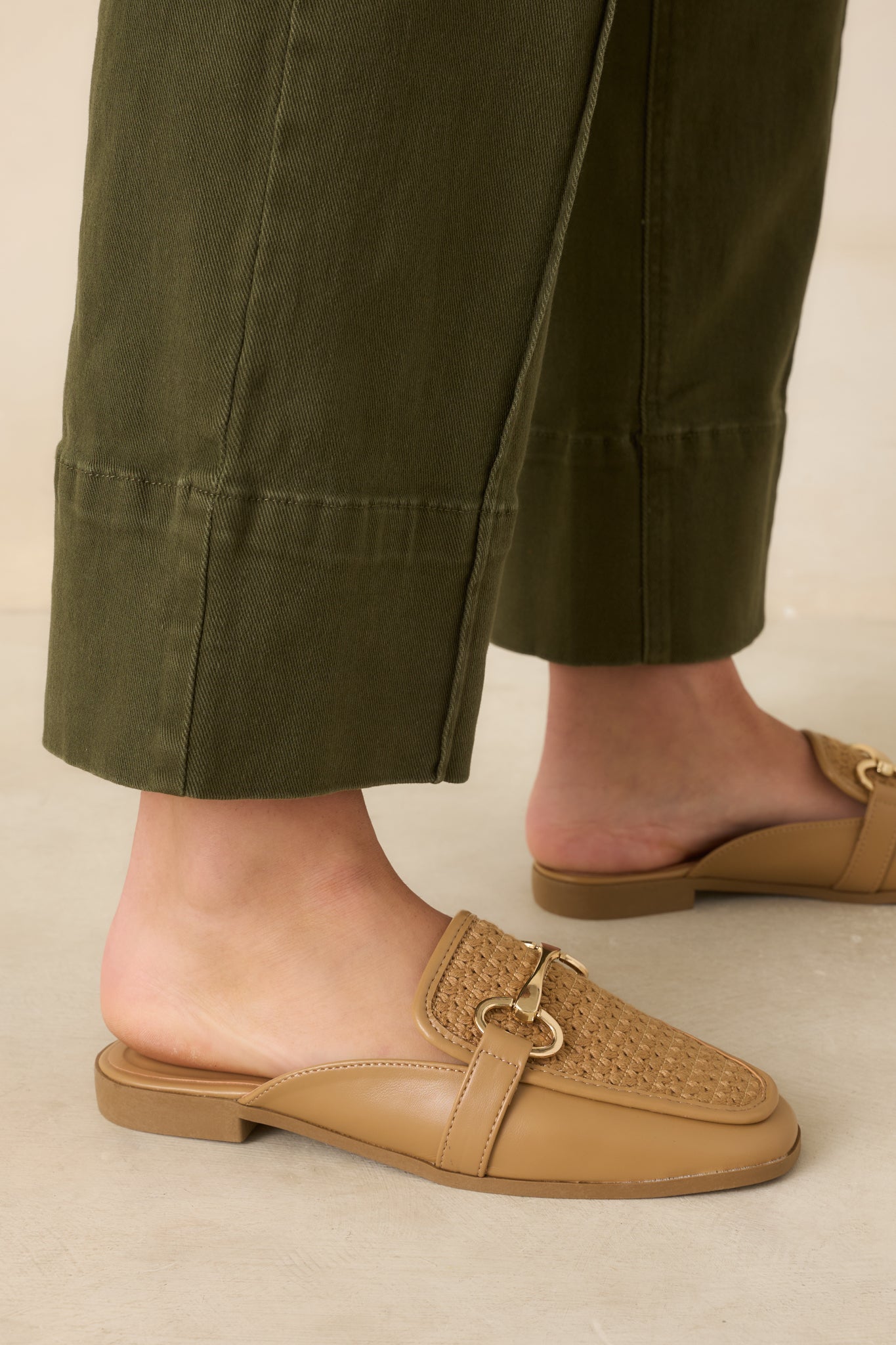 Textured slip-on loafers showcasing a timeless design, woven finish, and polished metallic accent.