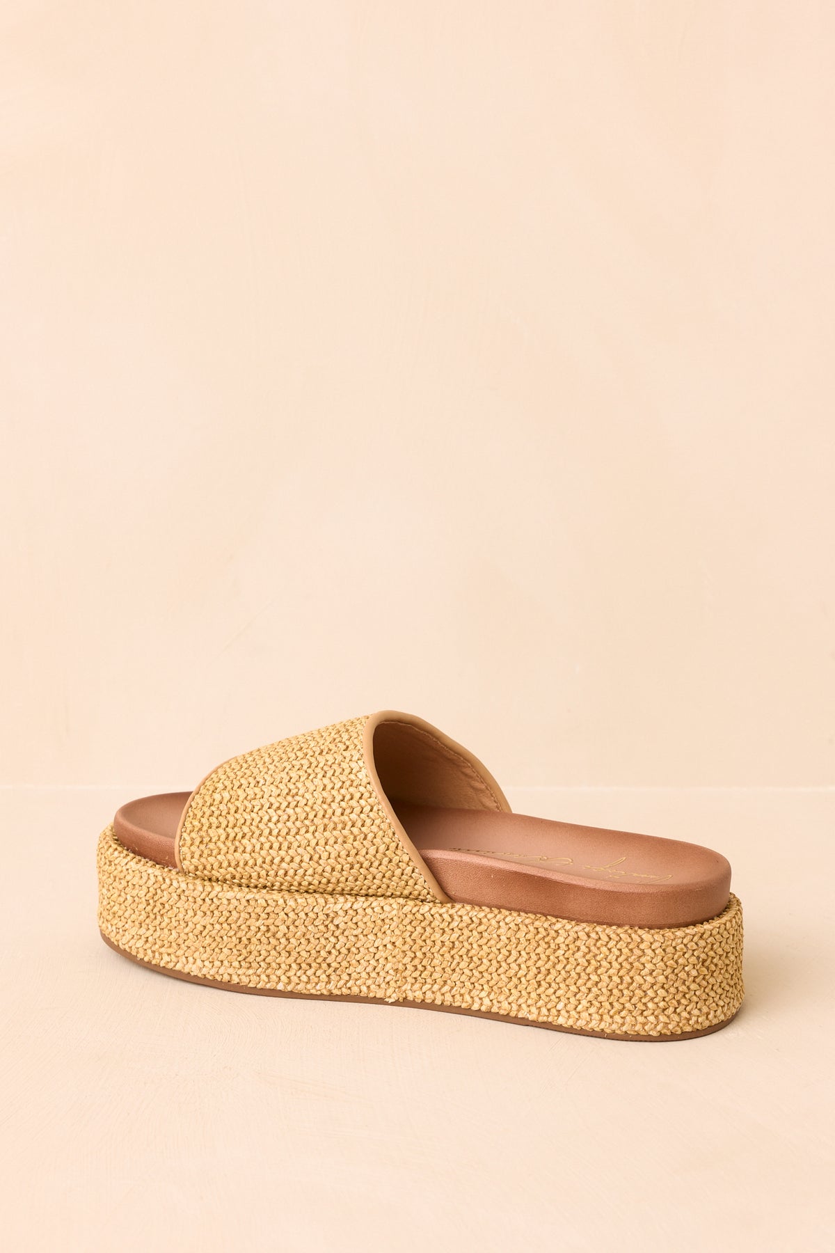 Textured platform sandals highlighting the wrapped sole and matching woven construction.