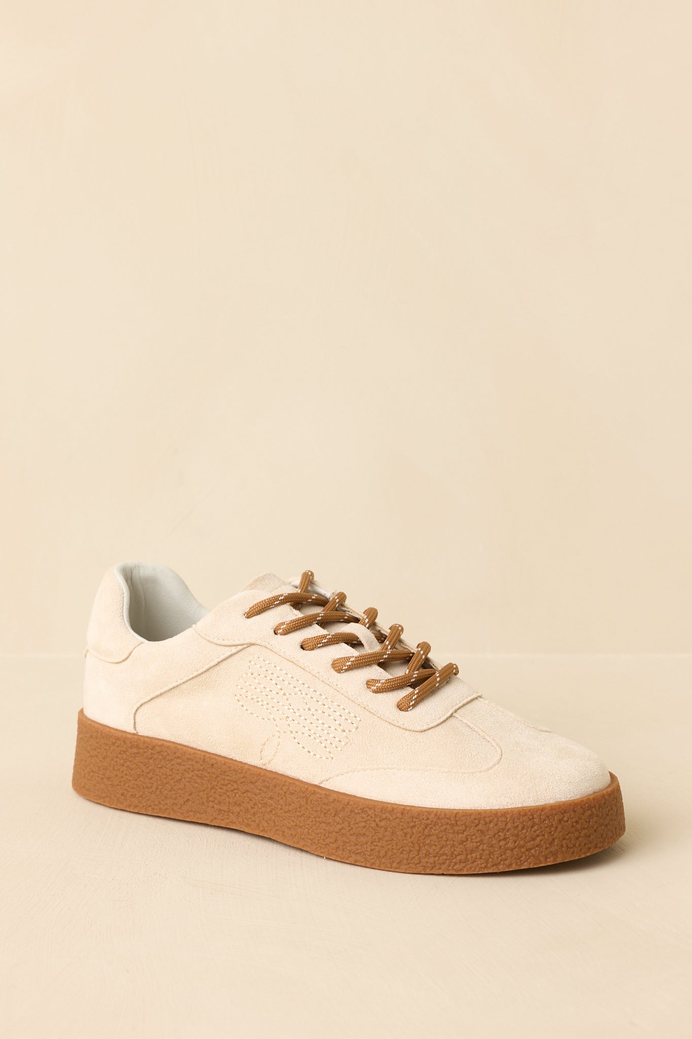 Three-quarter angle emphasizing the contrast laces, cushioned insole, and smooth faux suede upper.