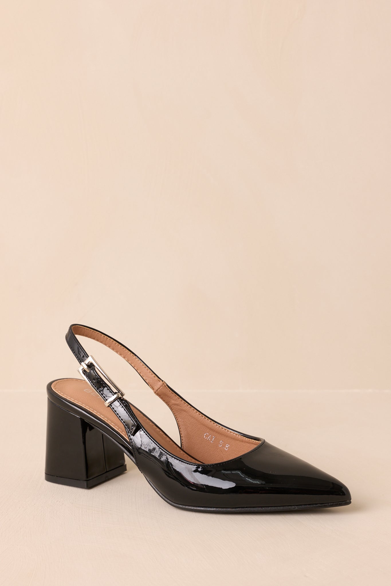 Three-quarter angle showing sleek silhouette and block heel design.