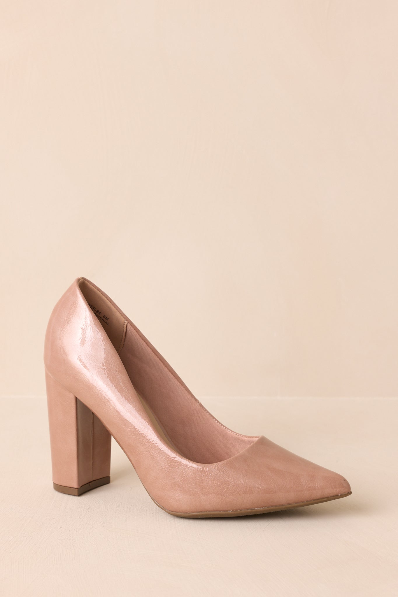 Three-quarter front angle showing slip-on design and shiny patent material.