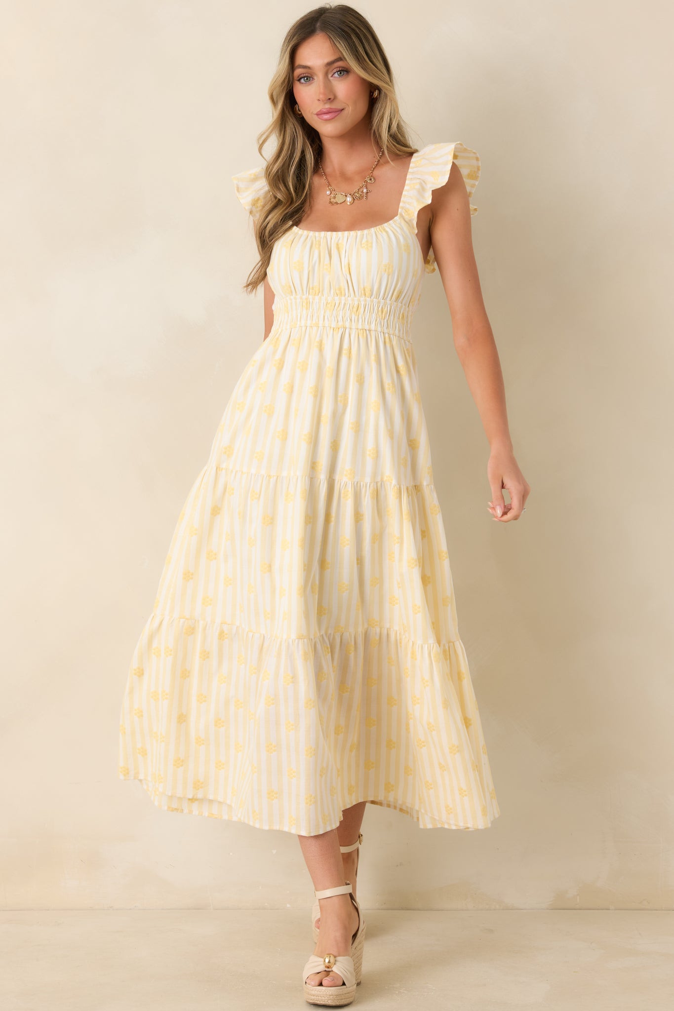 Tiered yellow floral maxi dress featuring a gathered neckline and lightweight embroidered cotton construction.